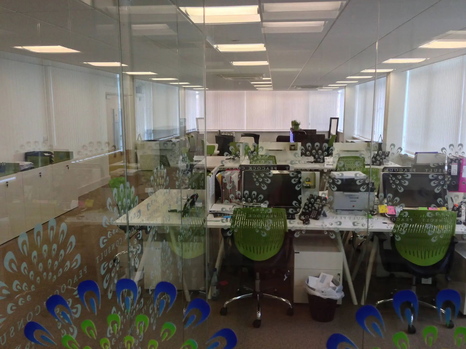 Back to office desks with chairs and pedestals and logo designed glass screens