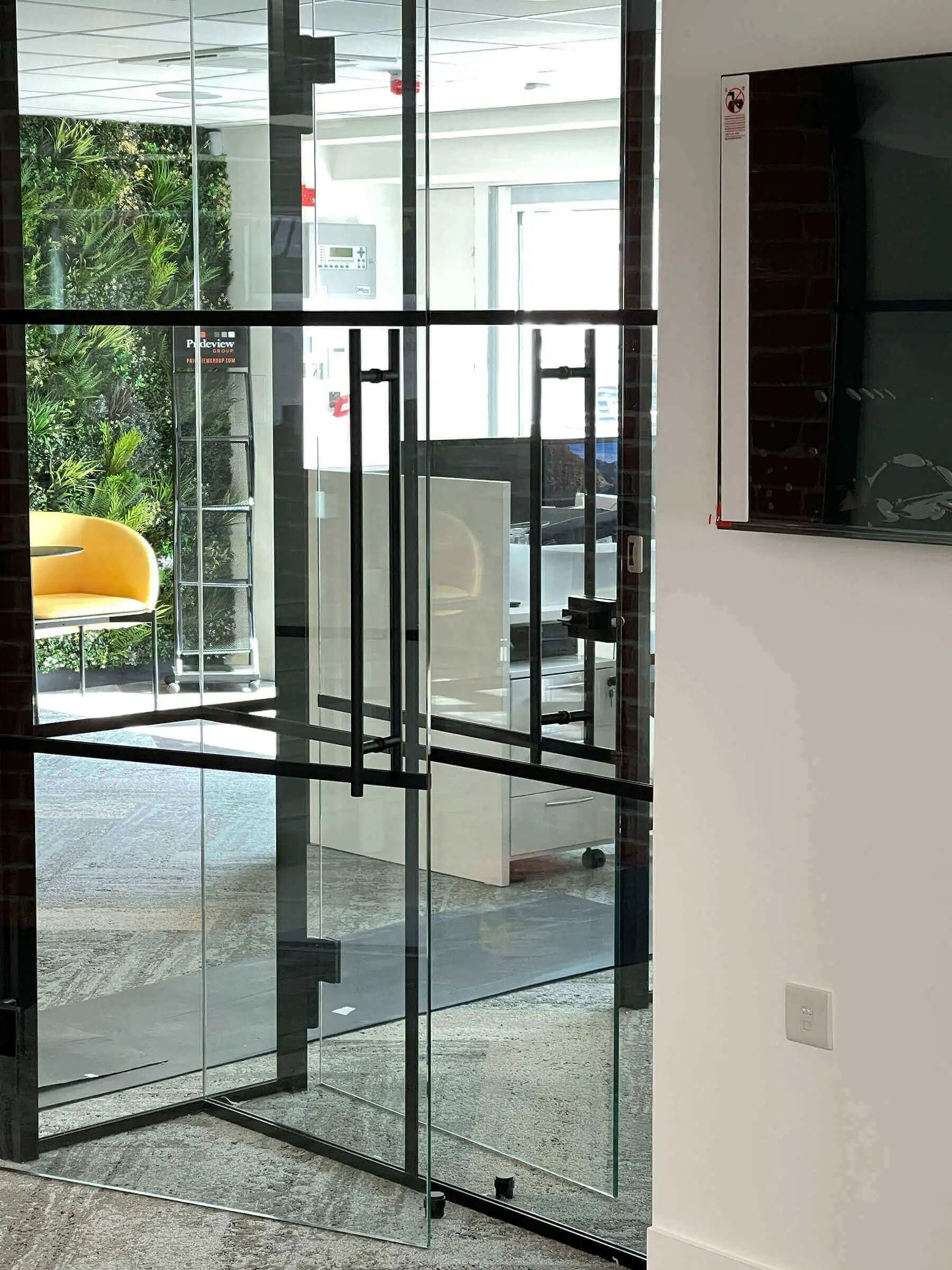 Black framed glass doors with full height handle