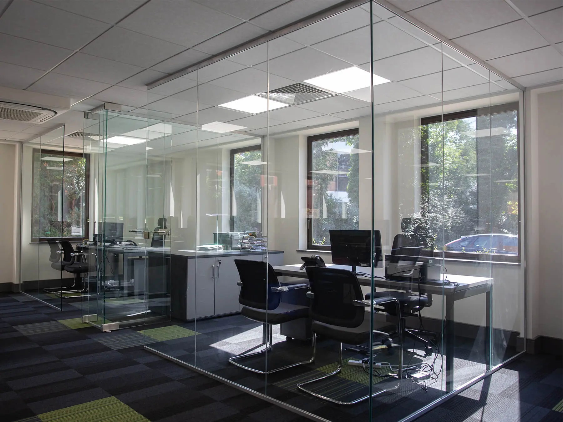CCP office space with executive desks chairs and glass partitions