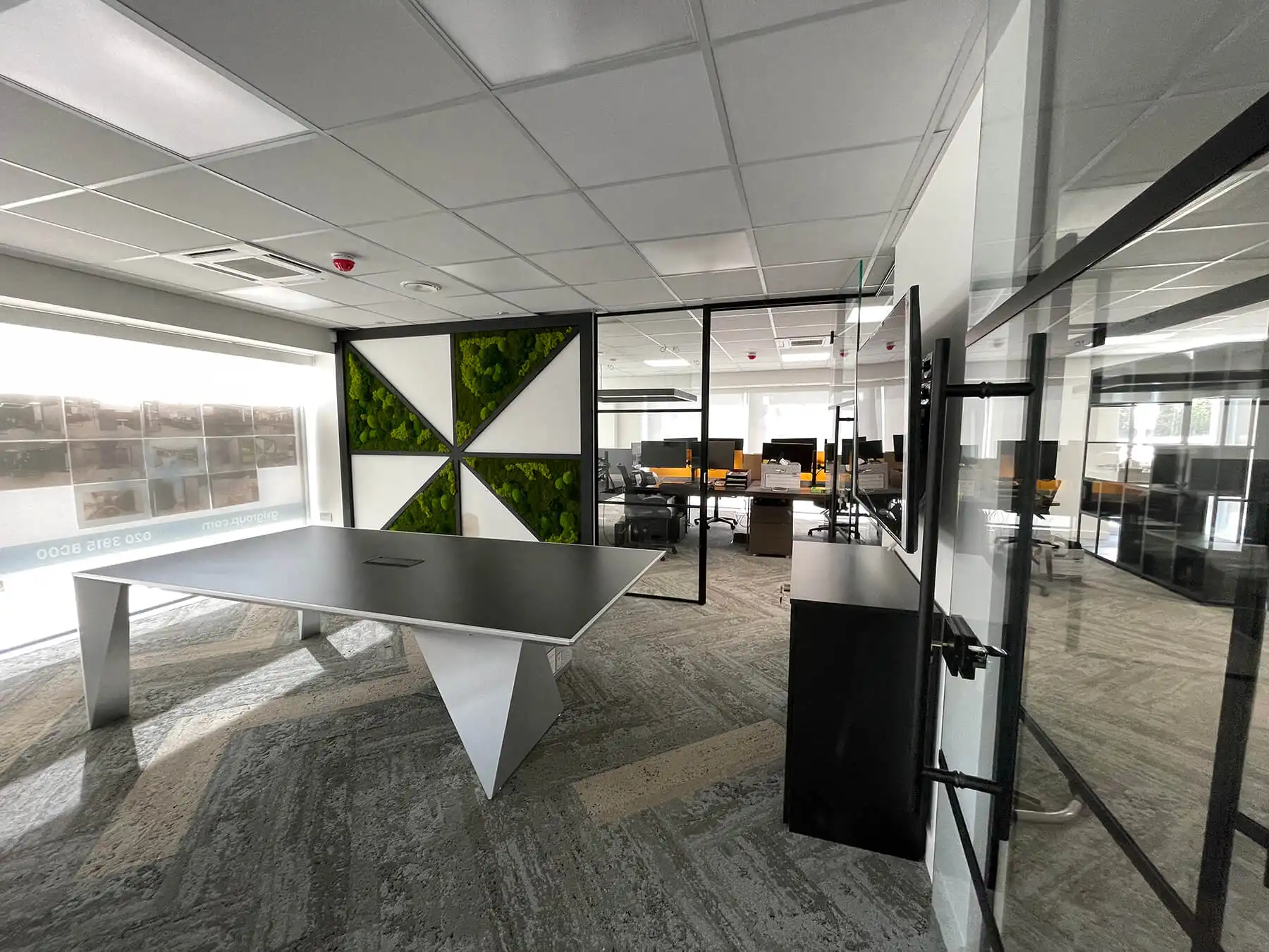Crazy Horse office space with designer furnitures and black framed glass partitions
