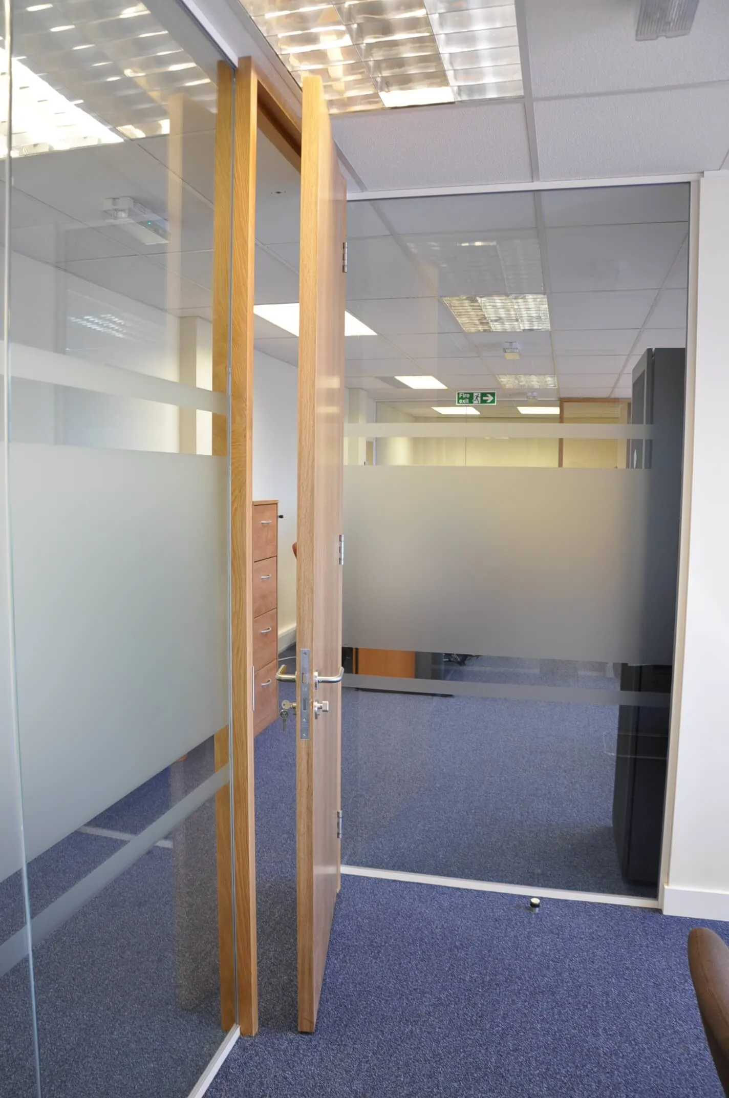 Designer floor in office with solid wood door along with glass partition