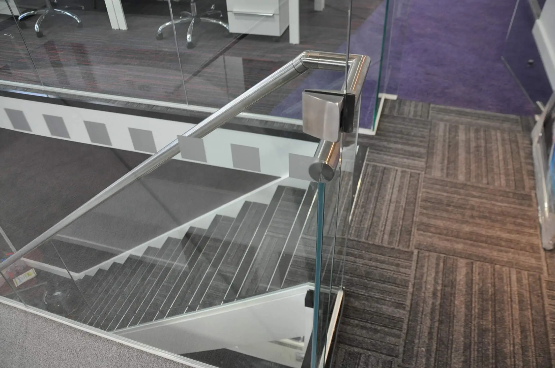Designer flooring and glass stairs in office space