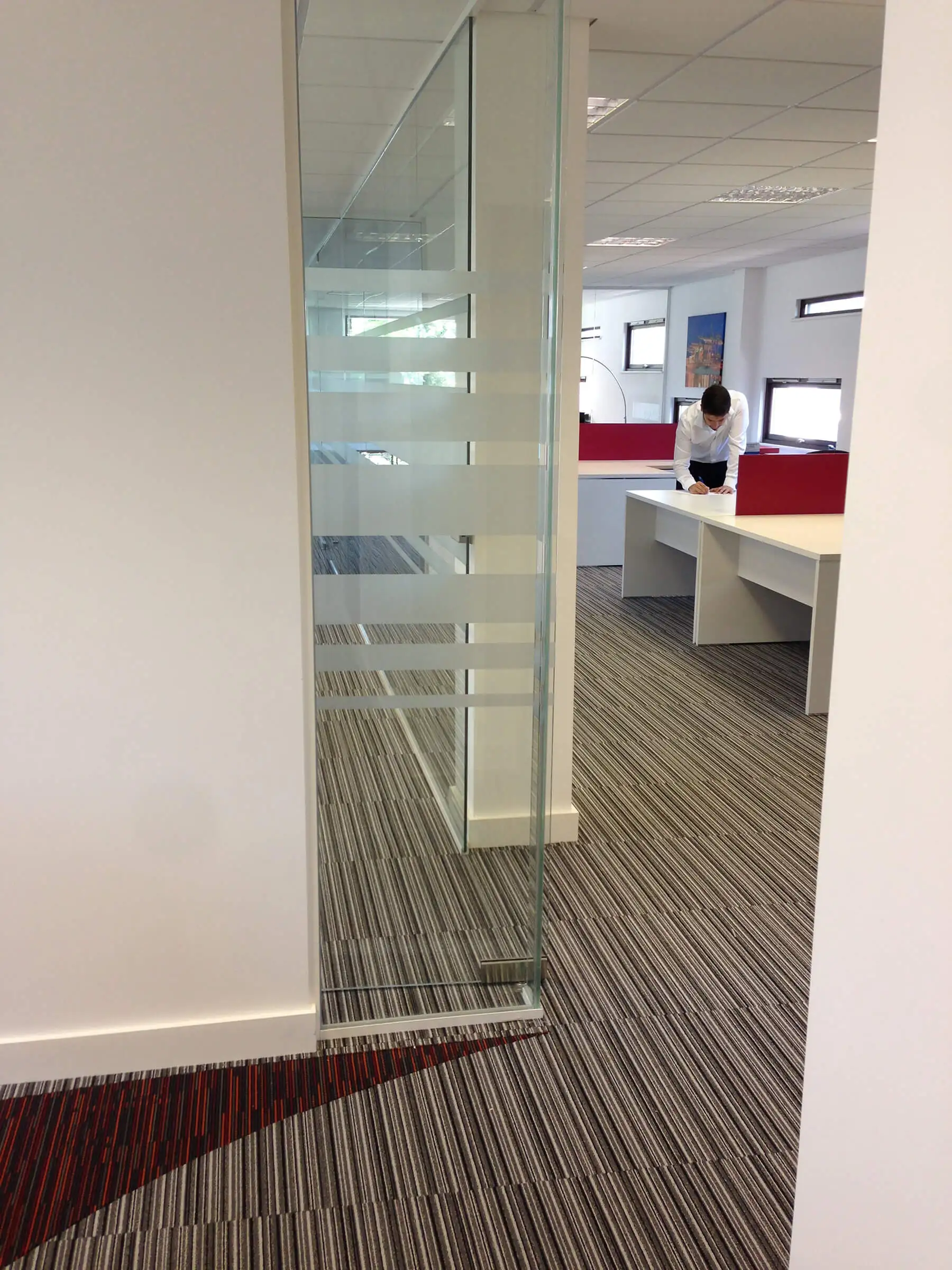 Designer flooring and single glazed glass partition in office space
