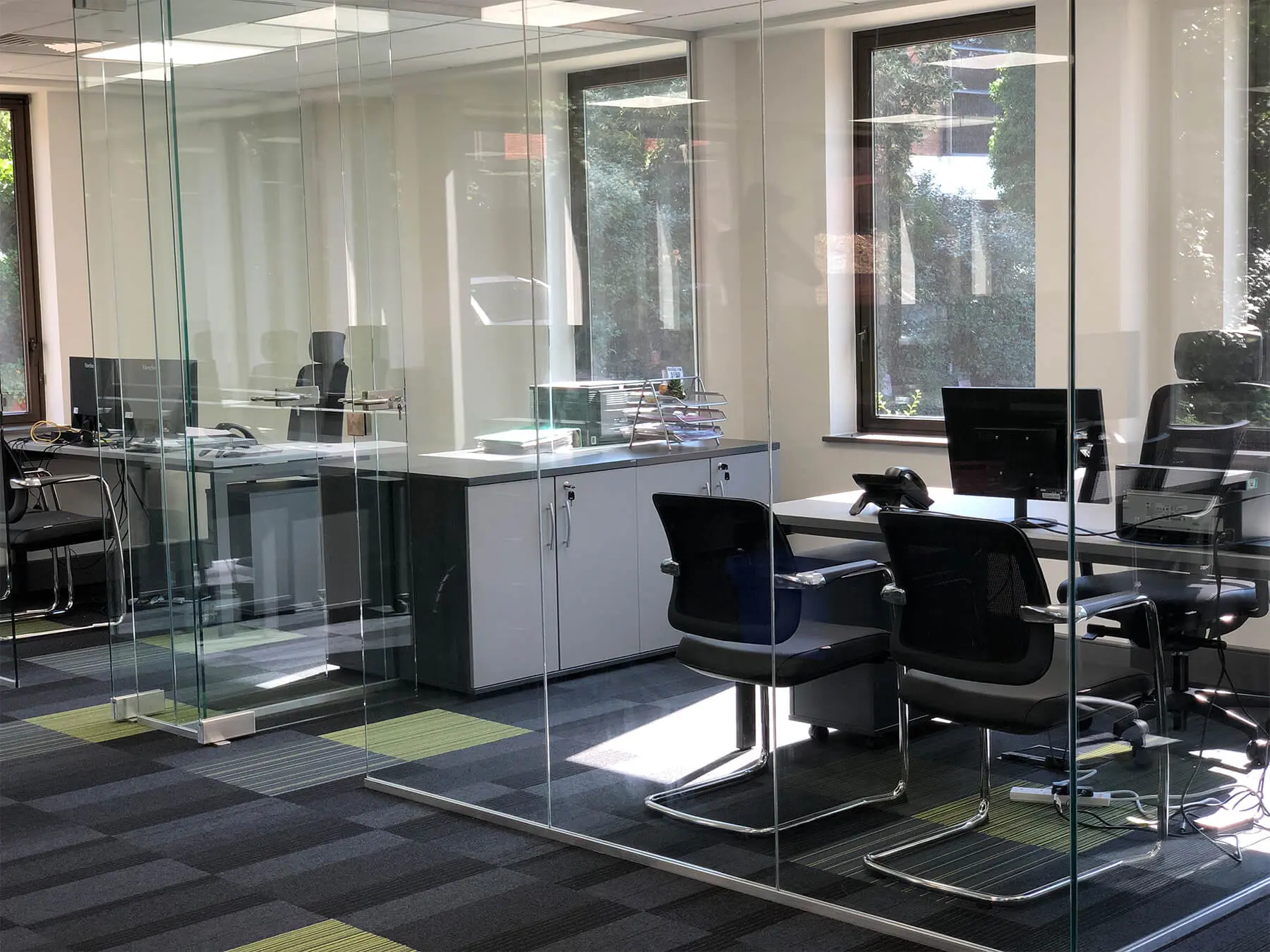 Designer furniture with glass separated walls in office
