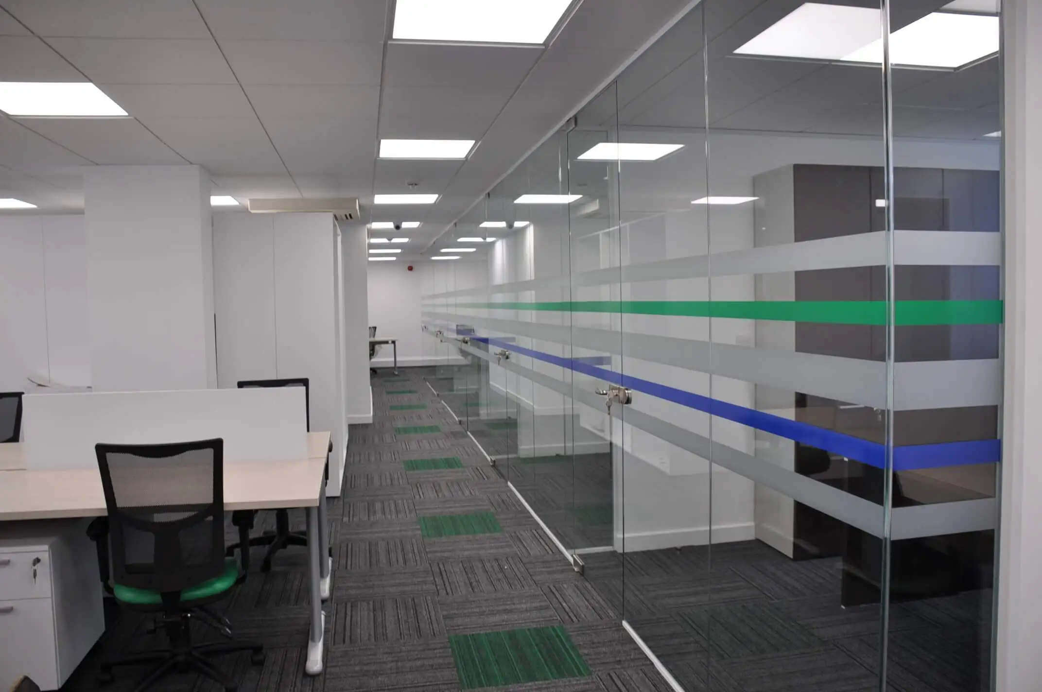 Designer glass partitions and floor in office work space