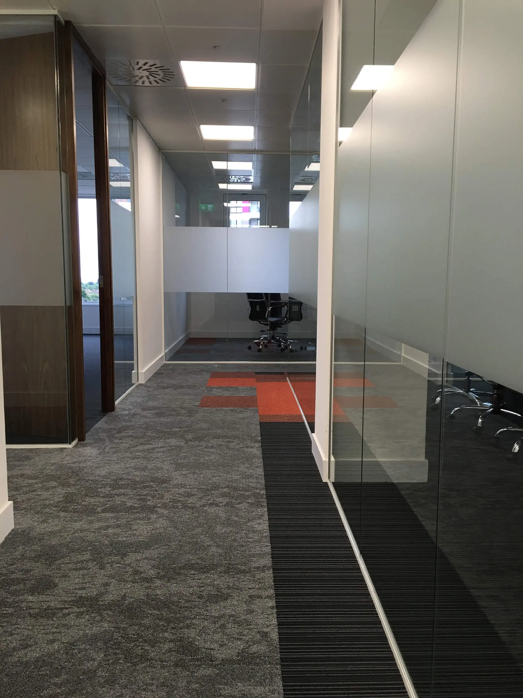 Designer office space divided with glass aprttions