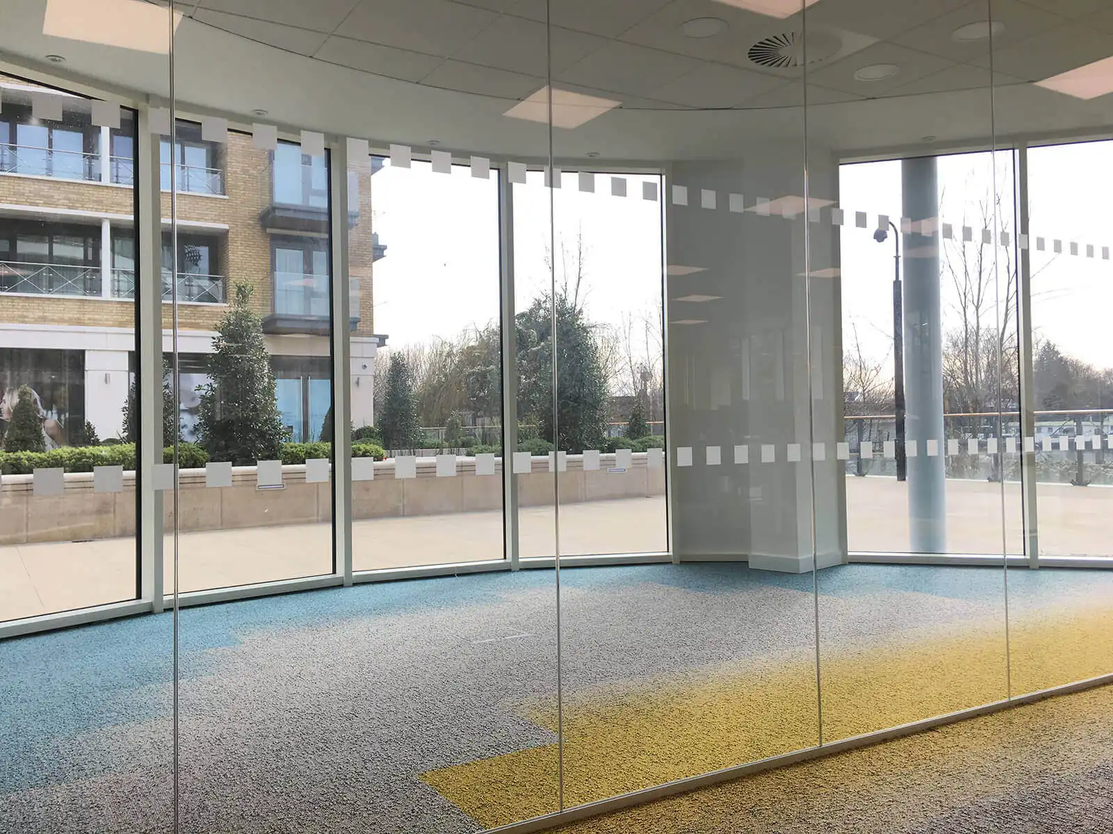 Dotted structural glass partition in office