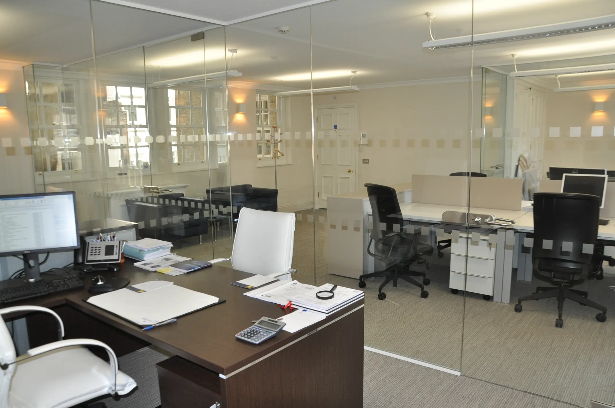 Executive and work area divided with glass partitions