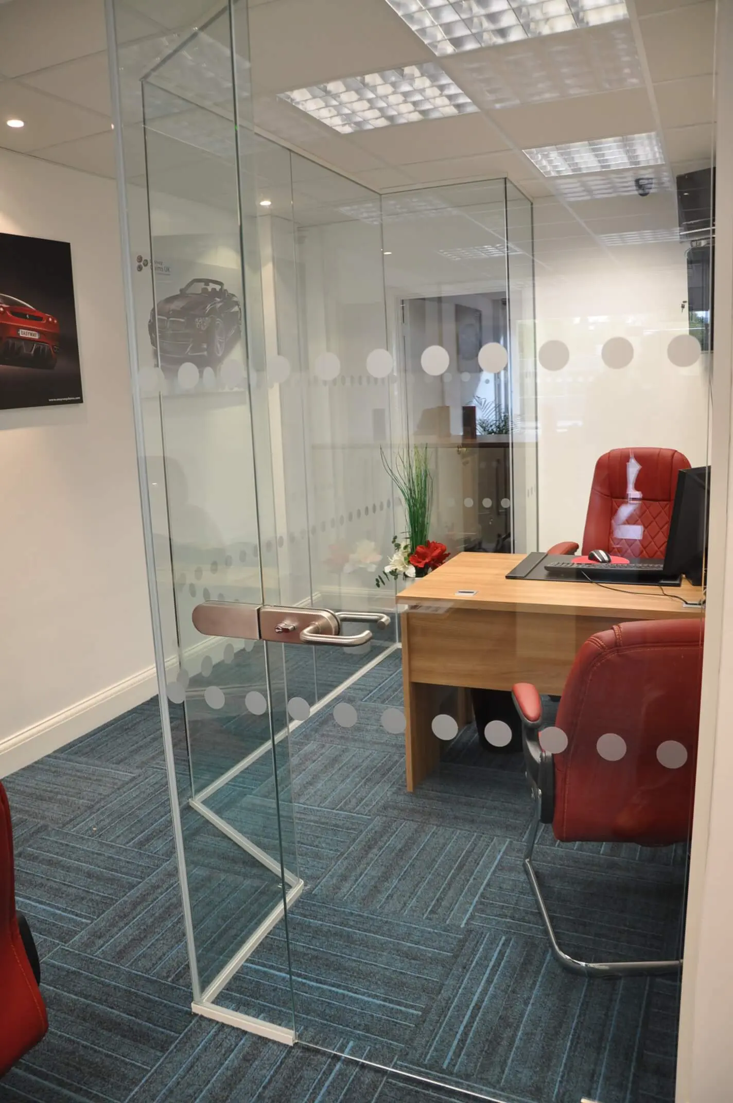 Executive office with desk chairs and dotted glass partitions