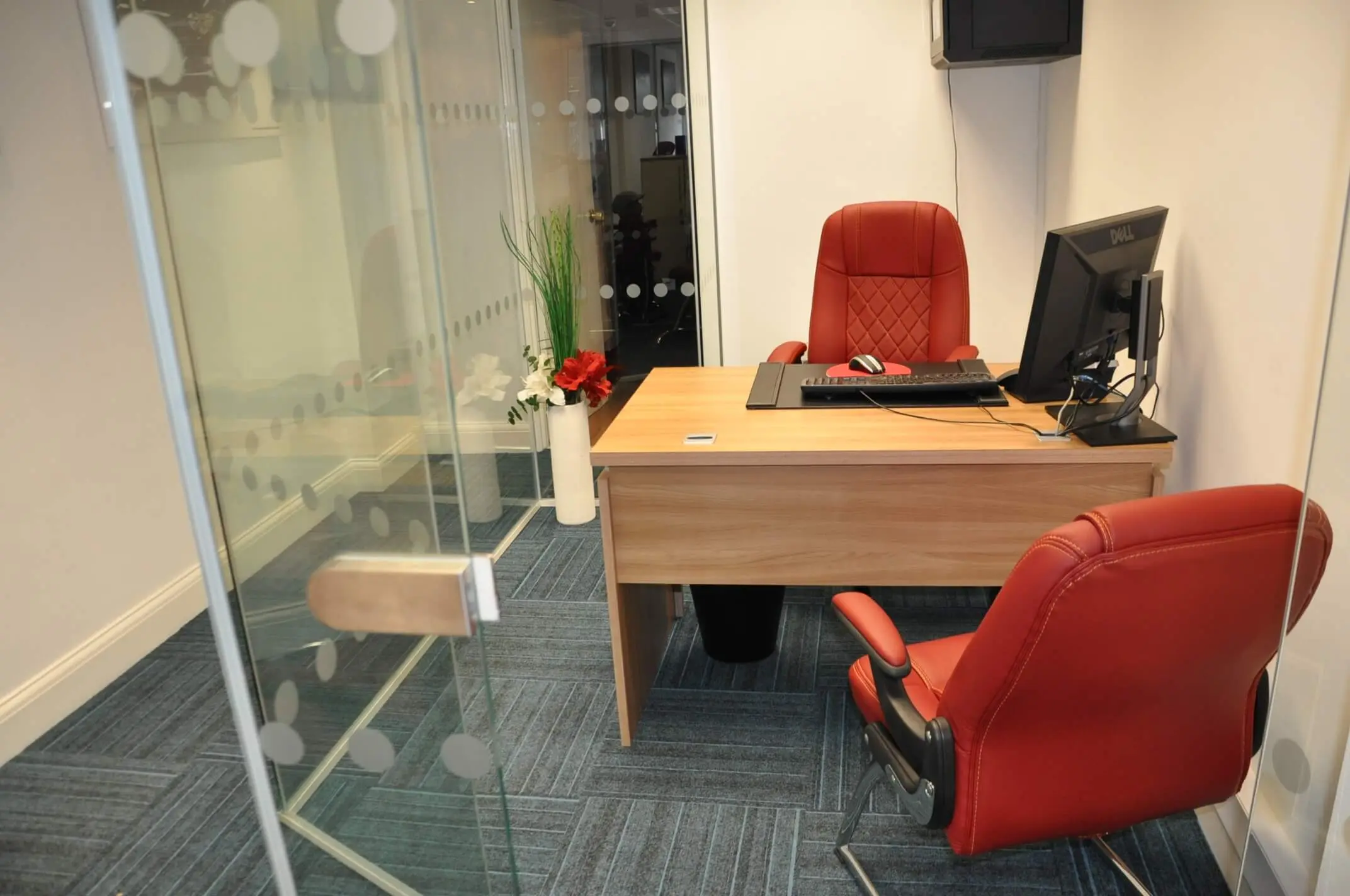 Executive space with desk chairs and designer floor