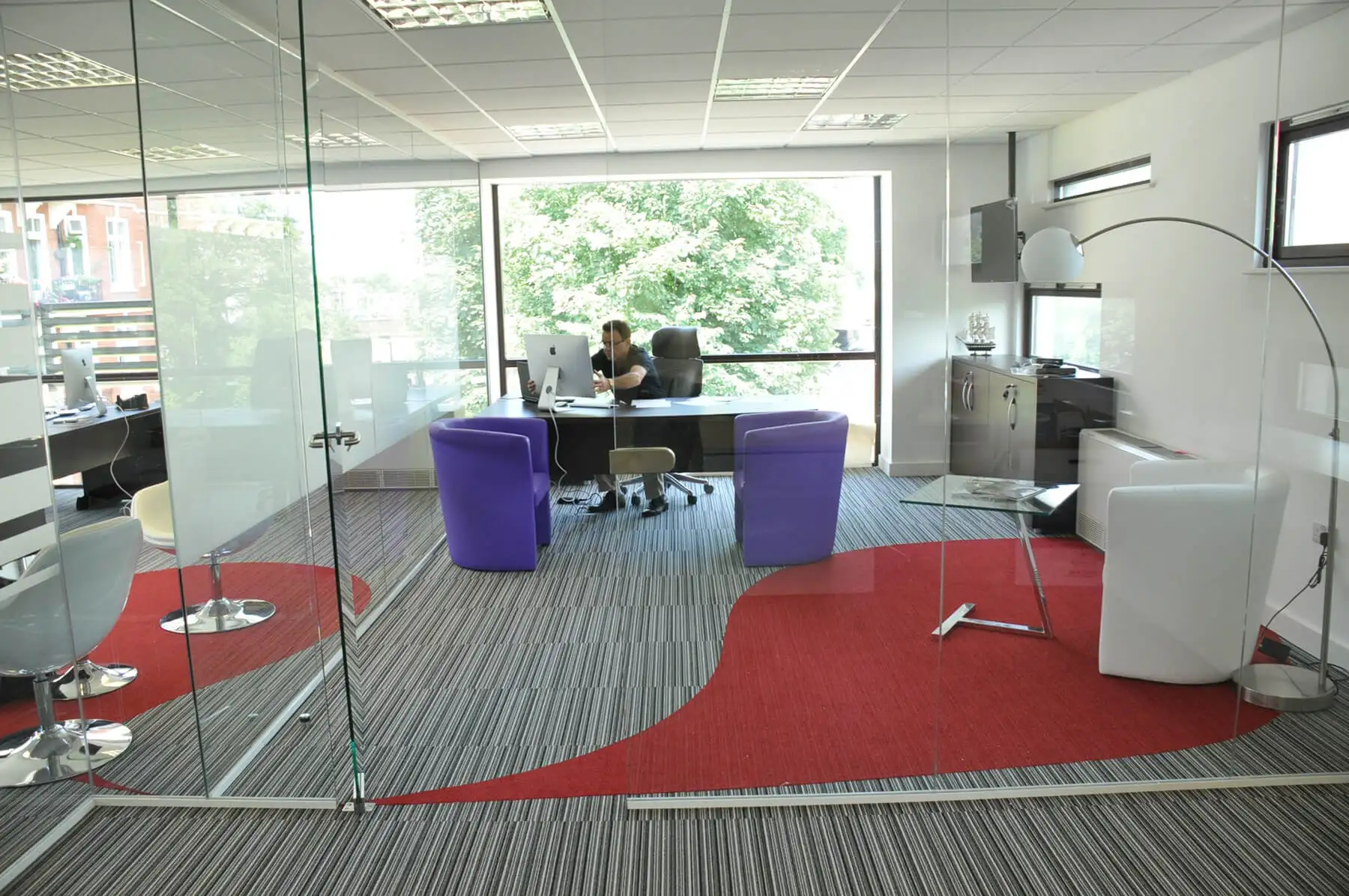 Executive work space with desk chairs armchairs and designer flooring