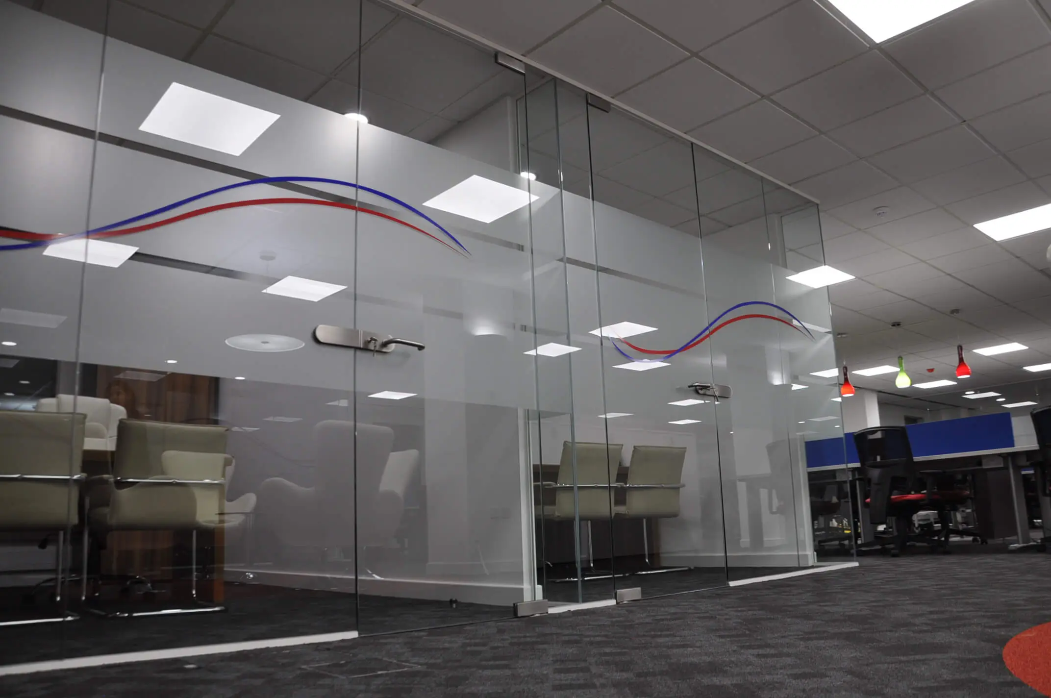 Executive work spaces area and co working area divided with frameless glass partitions