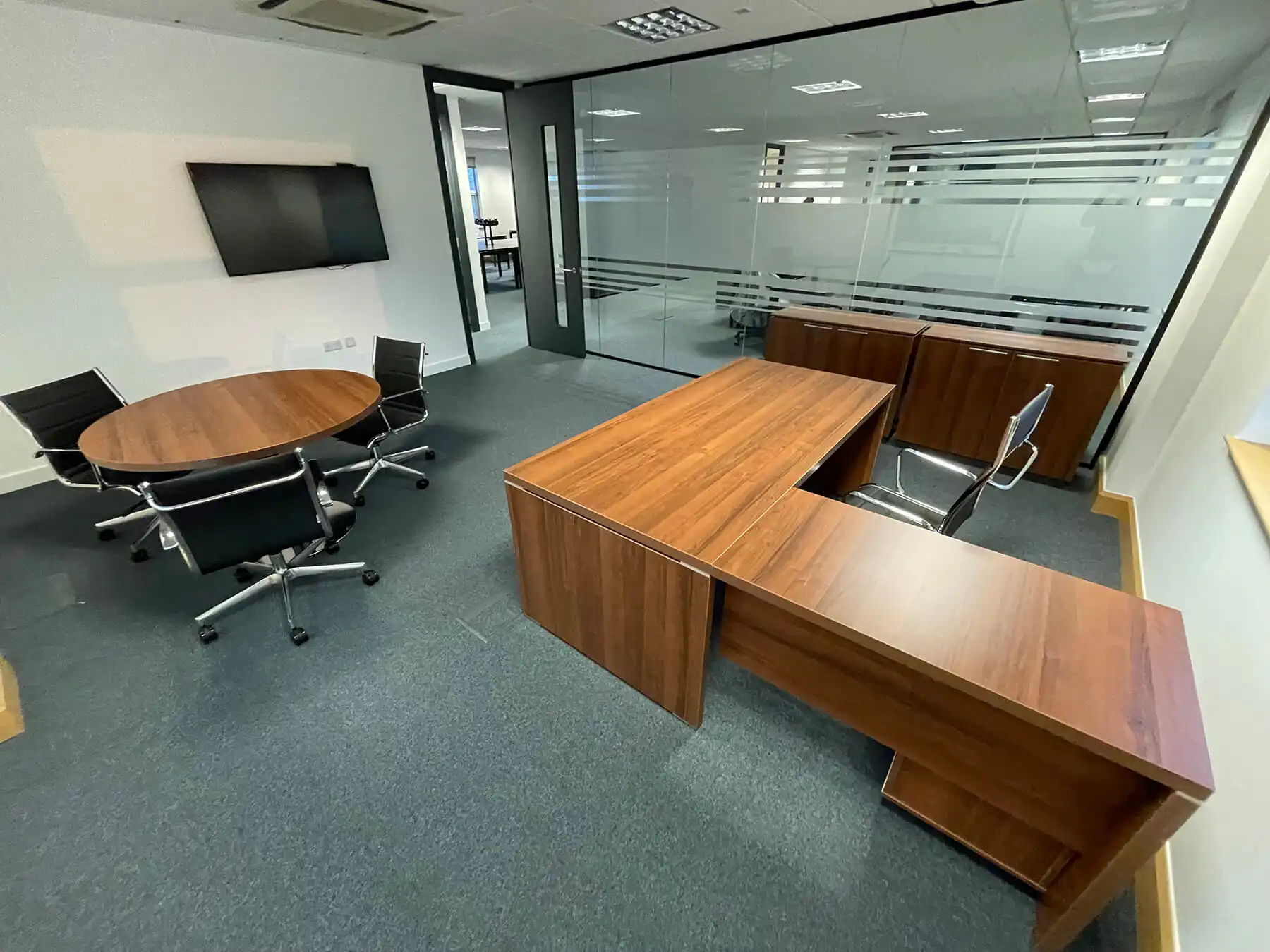 Flately Office with executive and meeting desks chairs and glass partitions with manifestation