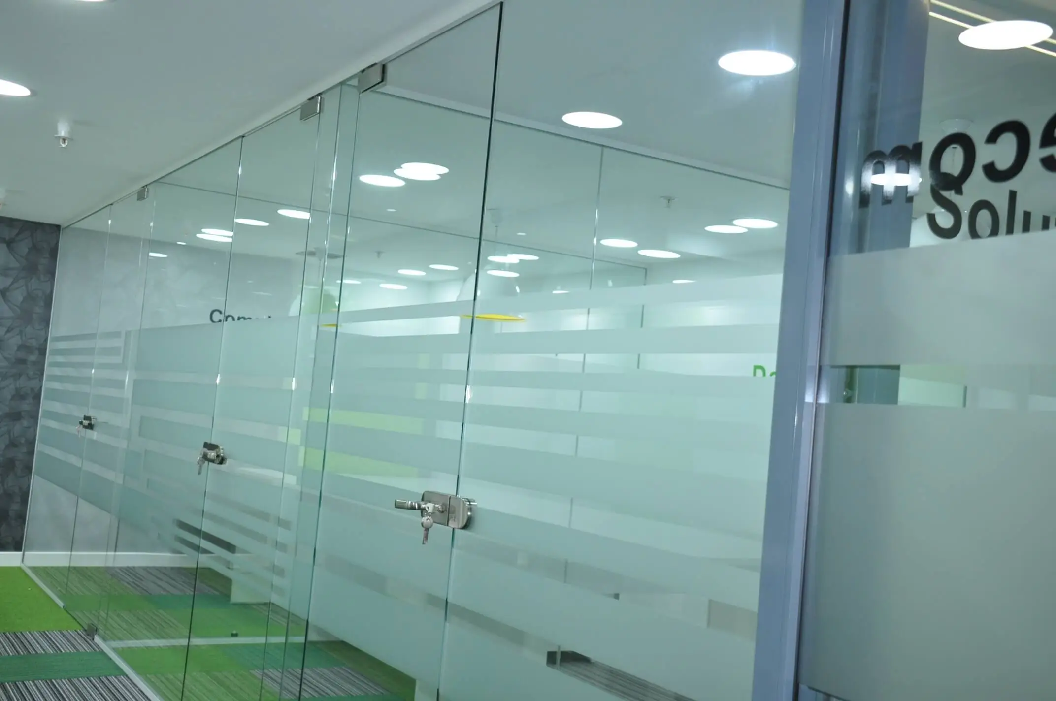 Frameless glass doors with locking system in office work space