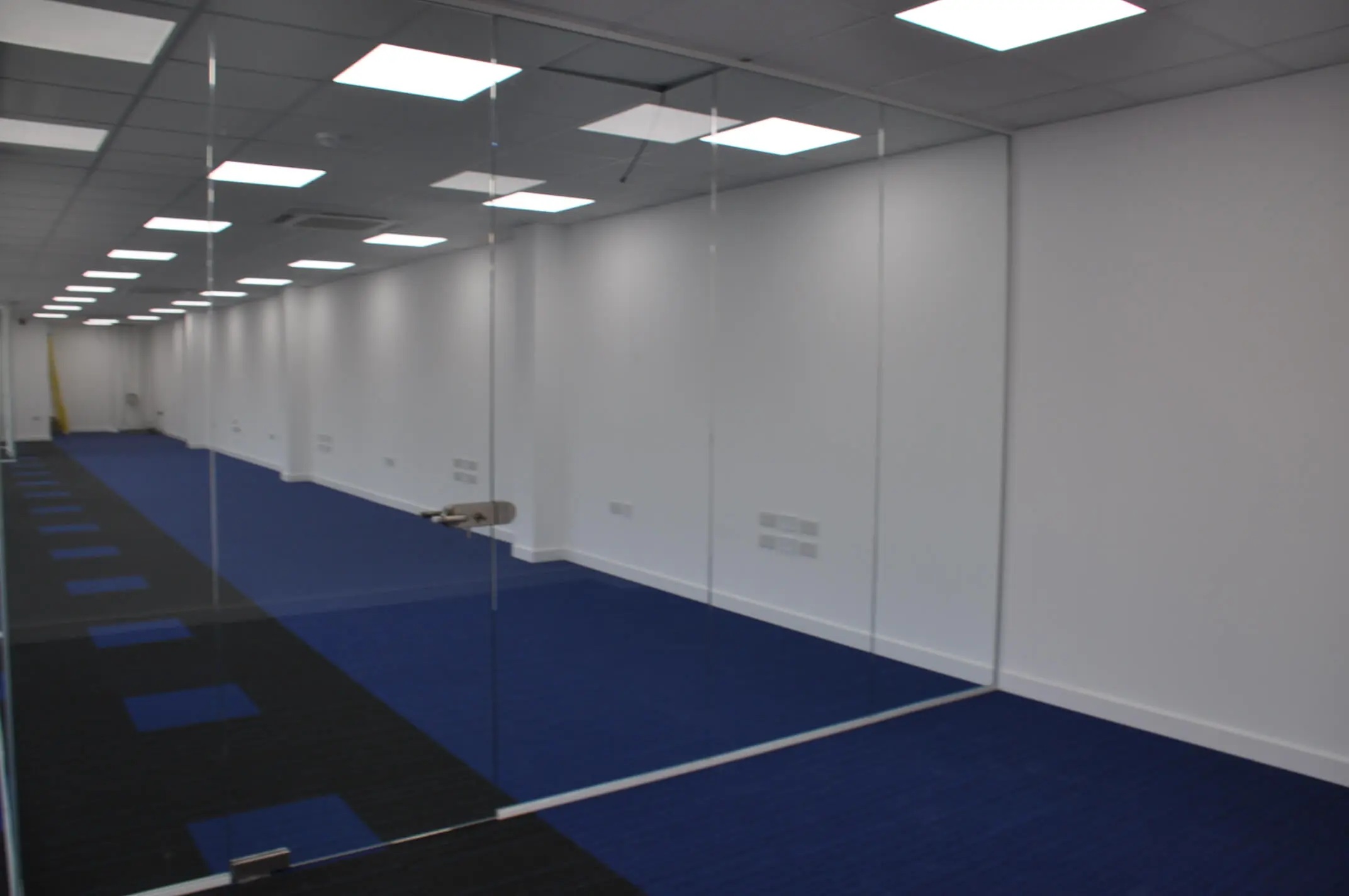 Frameless glass partitioning in large office space