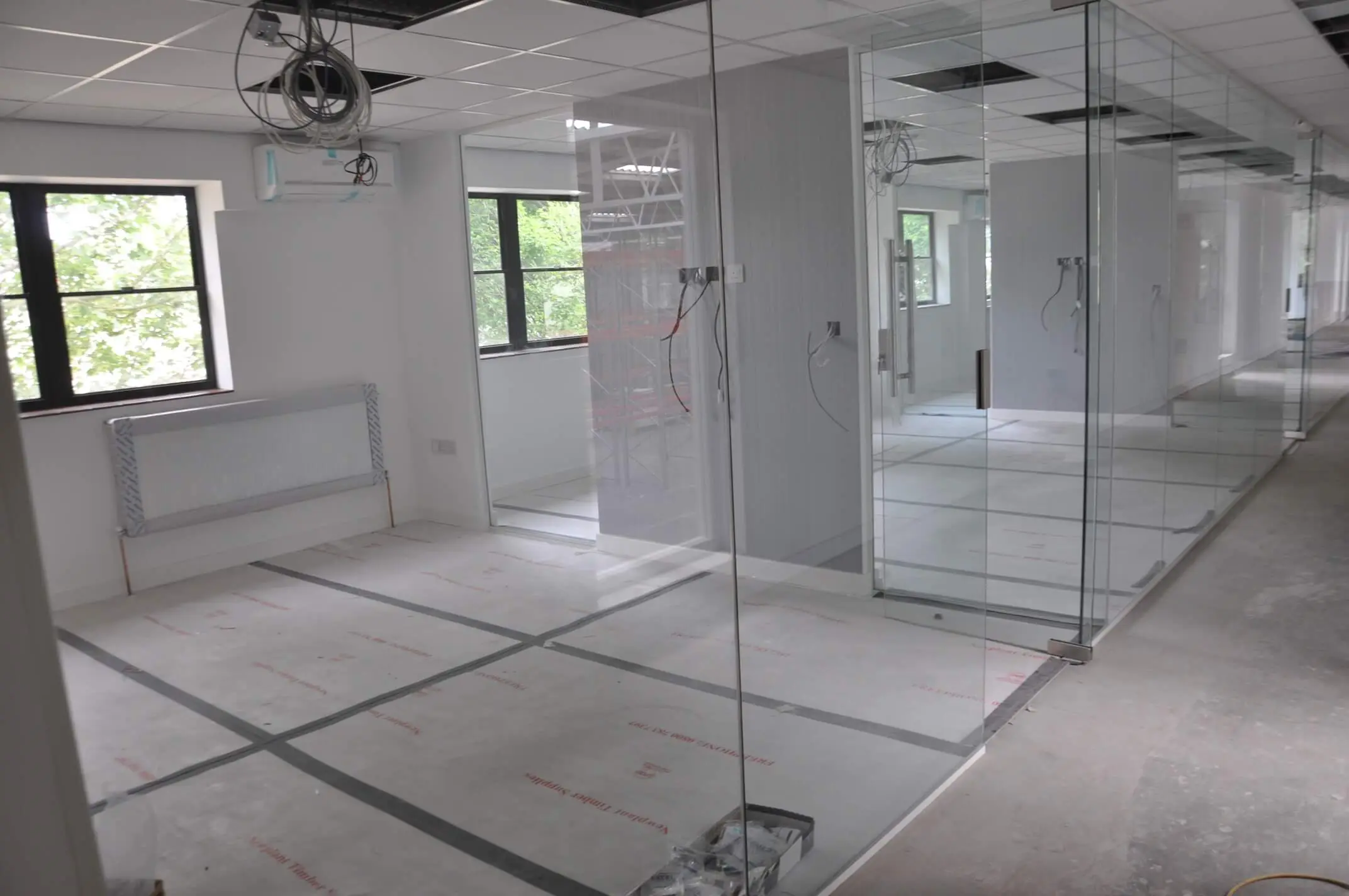 Frameless glass partitioning in office space