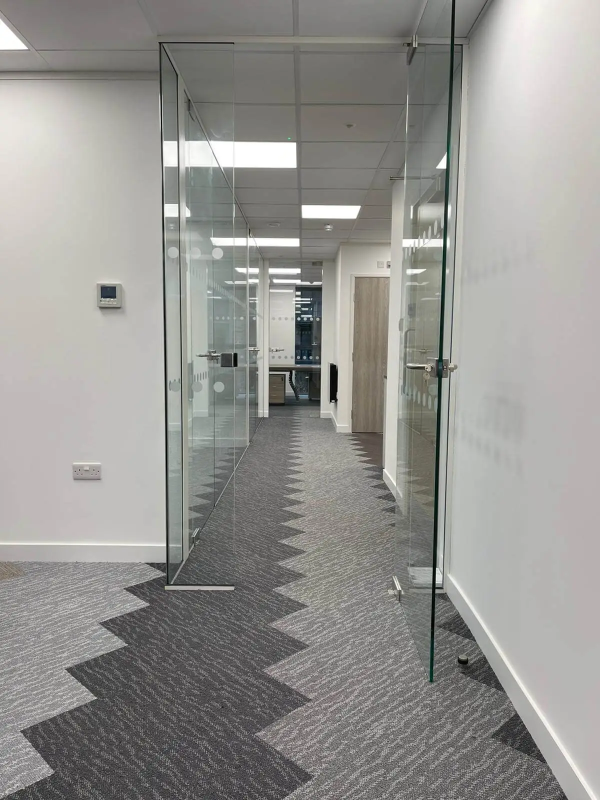Glass doors in office with designer floor