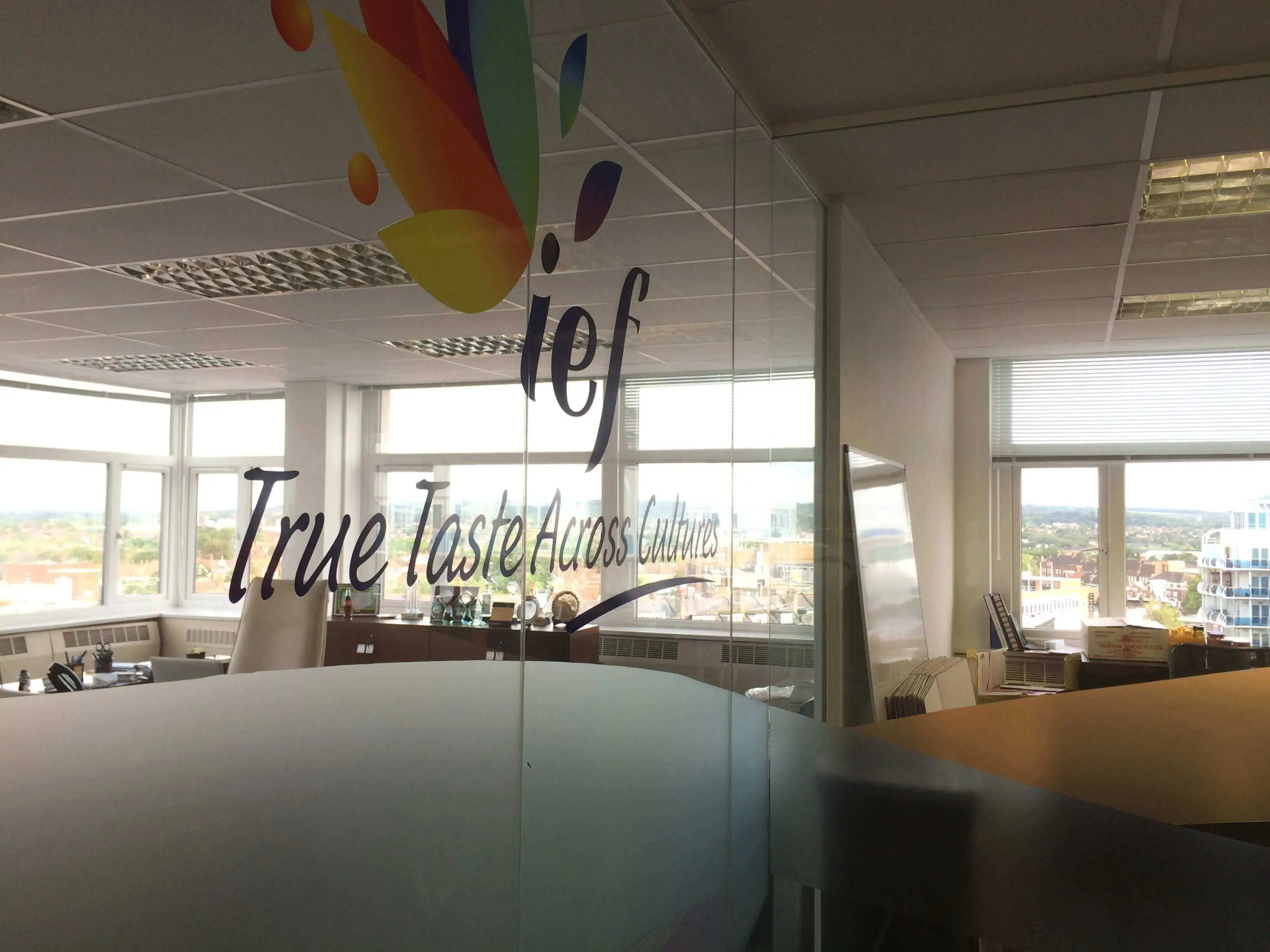 Glass partition with solid manifestation and logo cut out
