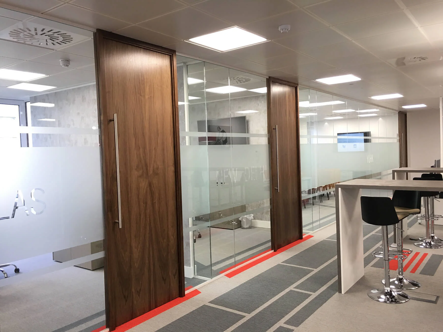 Glass partitions with high solid bands and wood doors