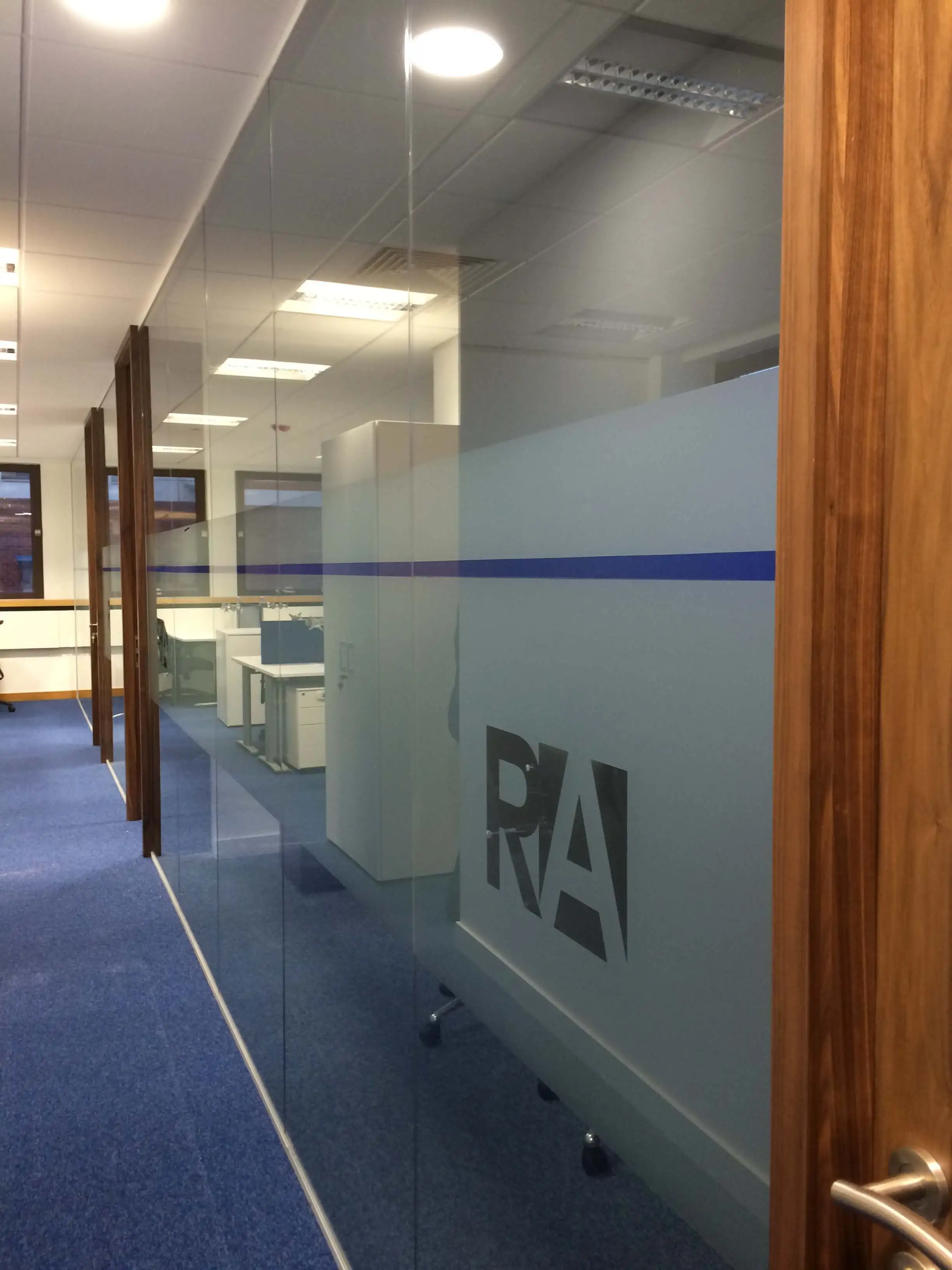Glass partitions with solid manifestation and solid wood and logo cut out