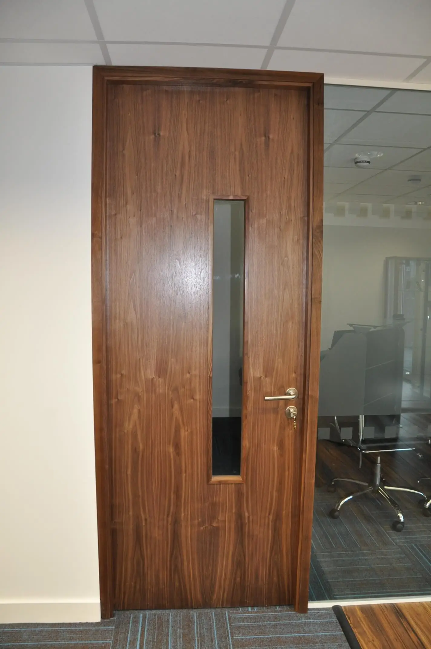 Glass partitions with solid wood door in the office