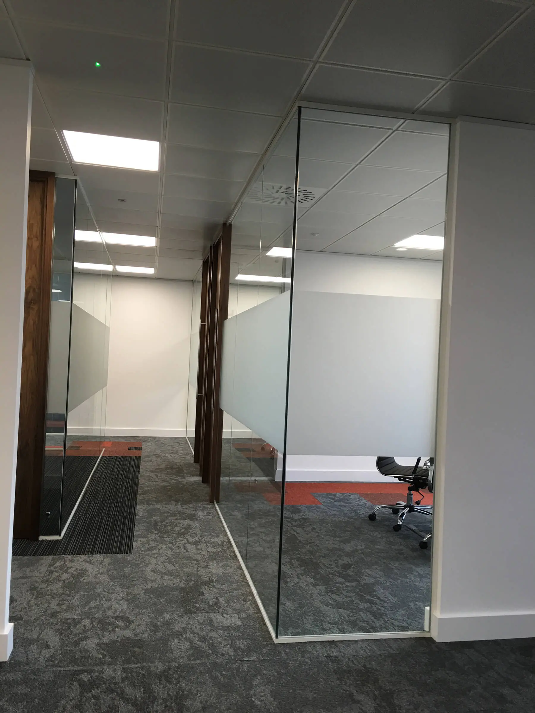 High solid band glass walls in office with designer floor