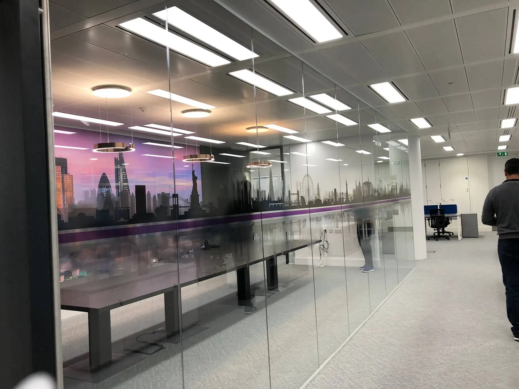 Large meeting table in glass partitioned meeting room