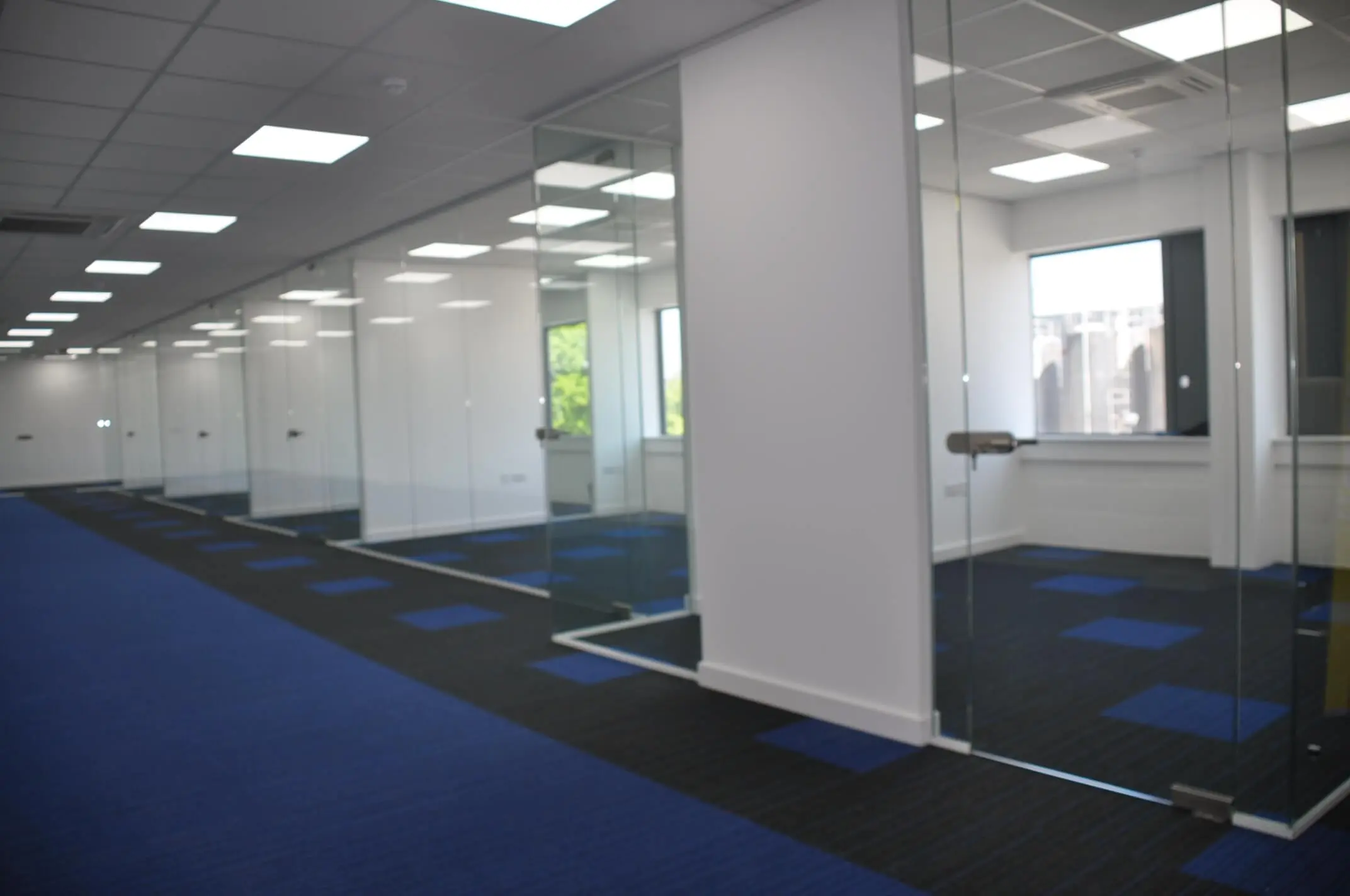 Large size office with designer office flooring and glass partition