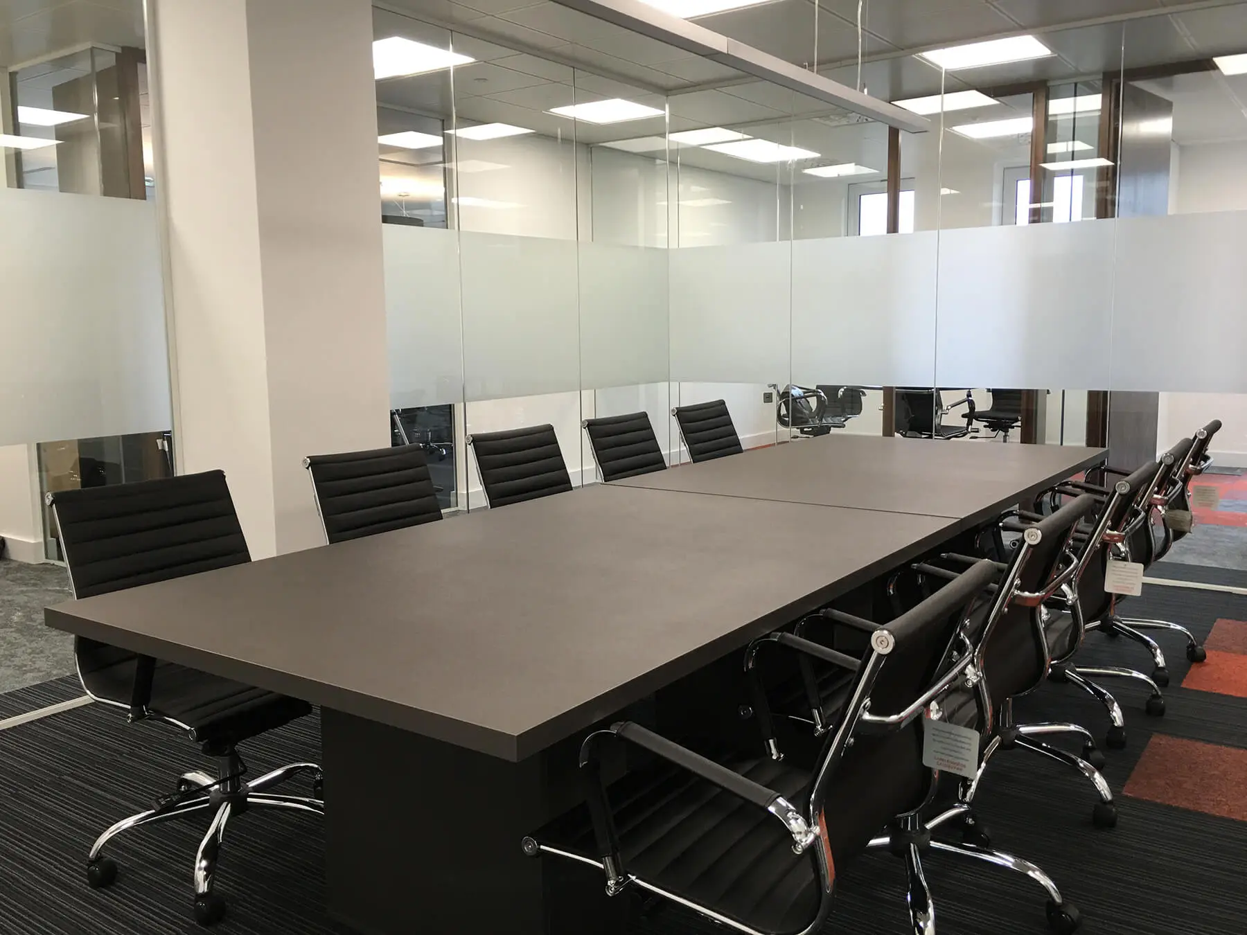 Meeting area with glass walls table and chairs