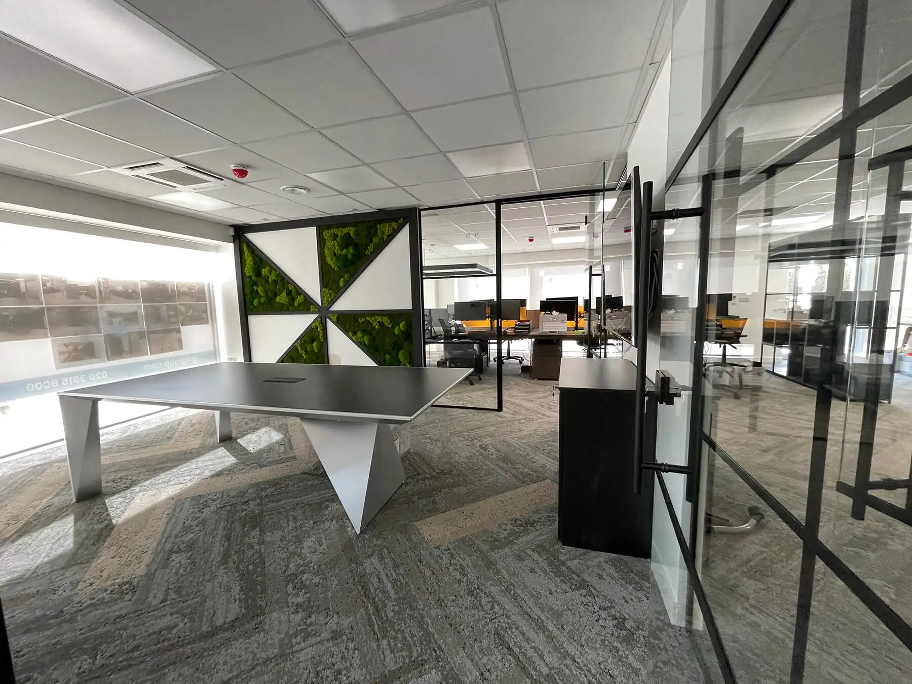 Meeting room and co working space divided with black frmaed glass partitions