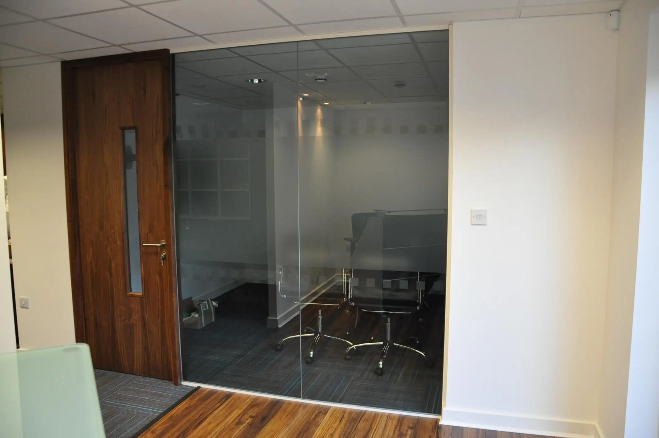 Meeting room glass partitions with solid wood finish doors