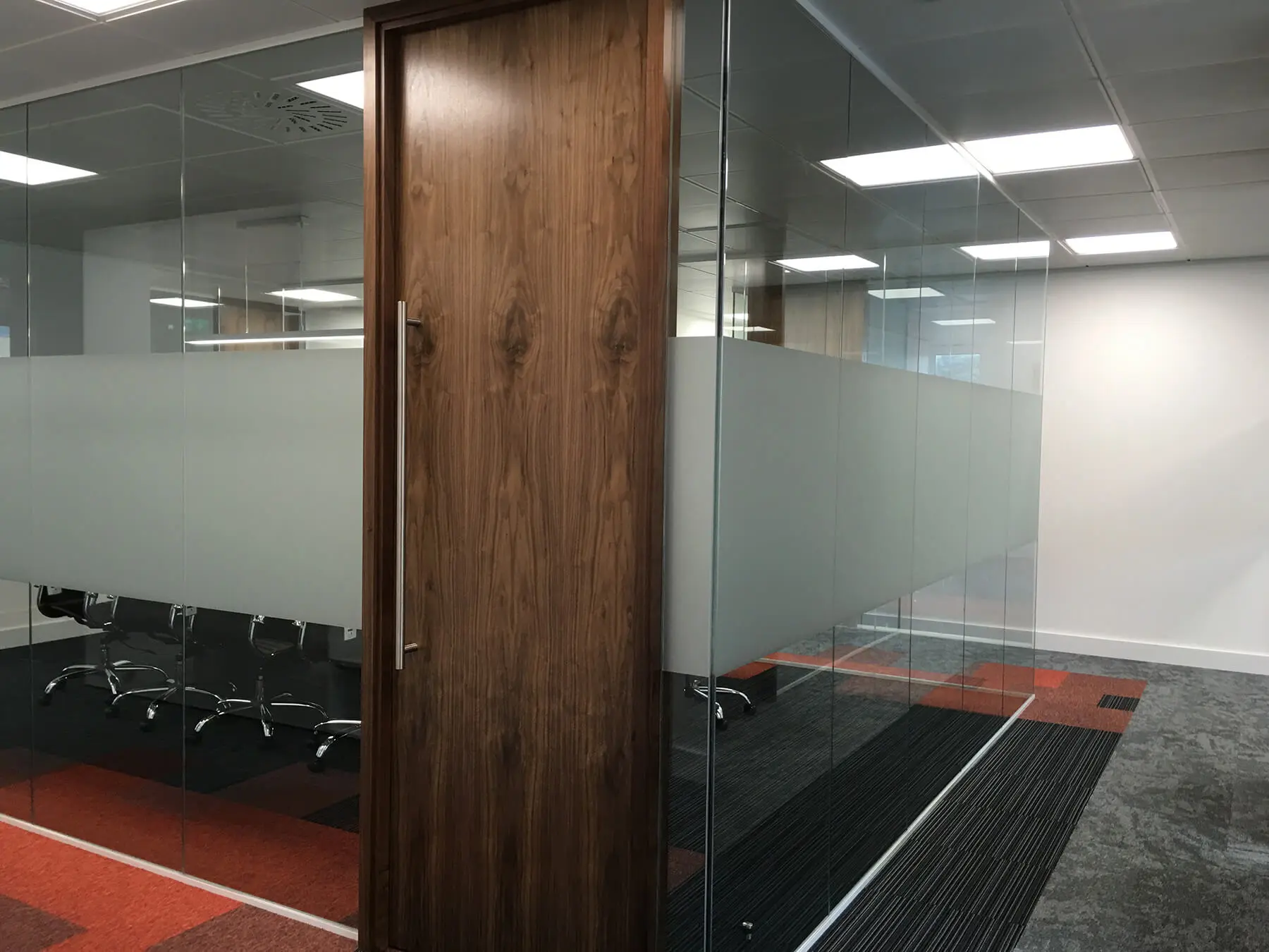 Meeting room with glass manifestation and wood door