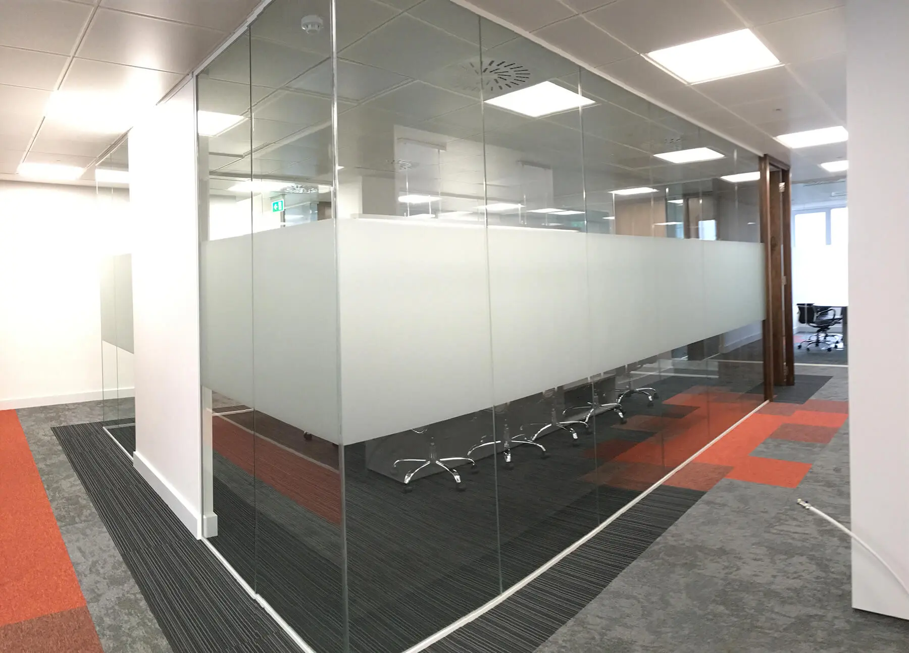 Meeting room with glass walls with high solid band on it
