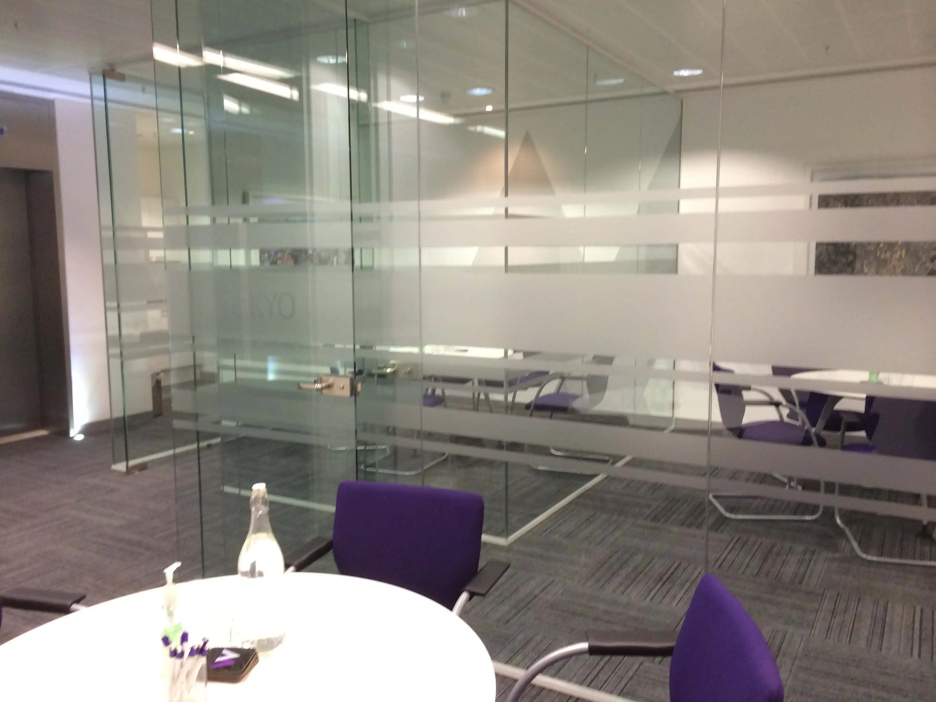 Meeting rooms with several tables chairs and glass partitions