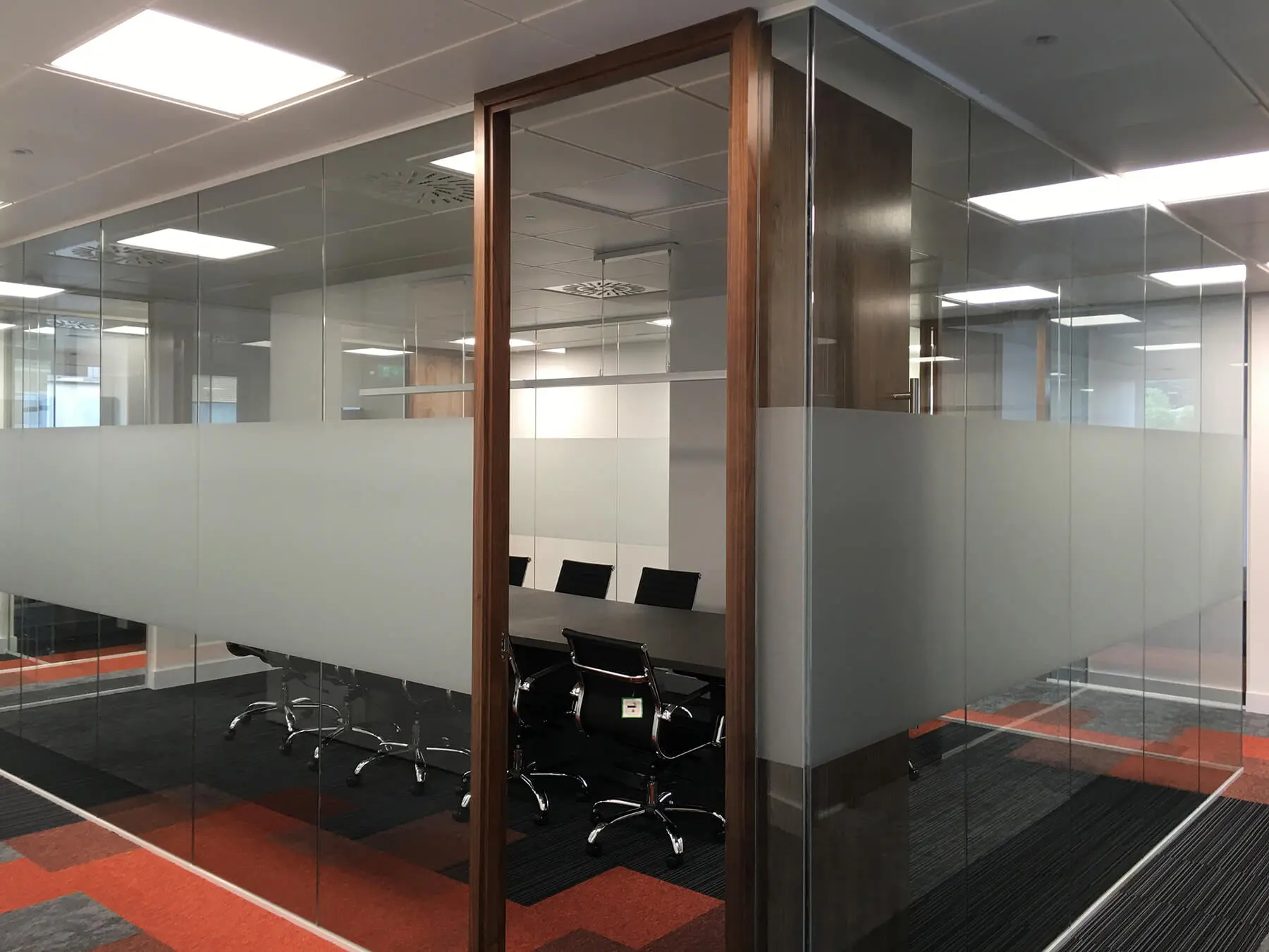 Meeting space with glass walls and wood door
