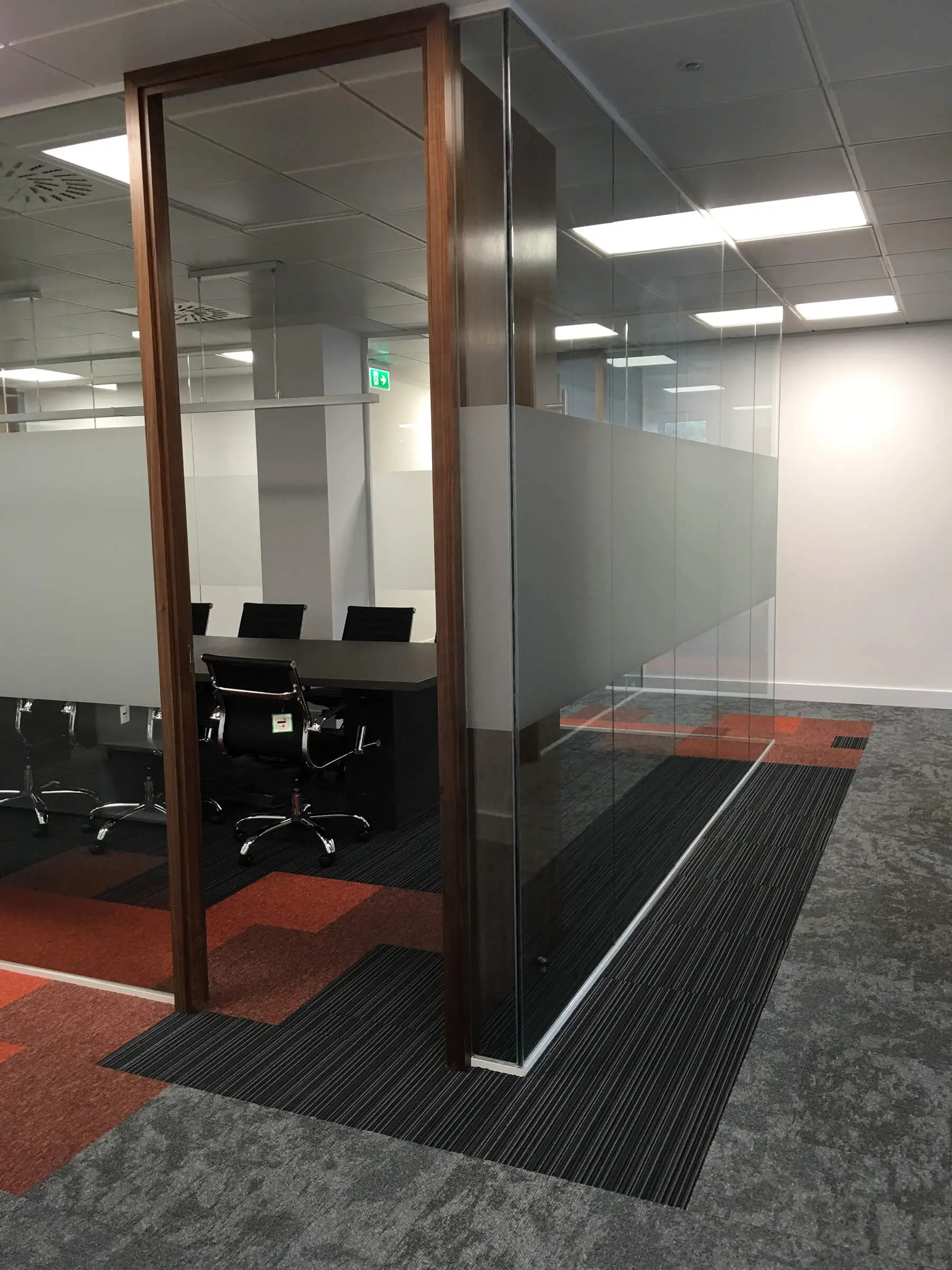 Meeting space with high solid band on glass walls and designer floor