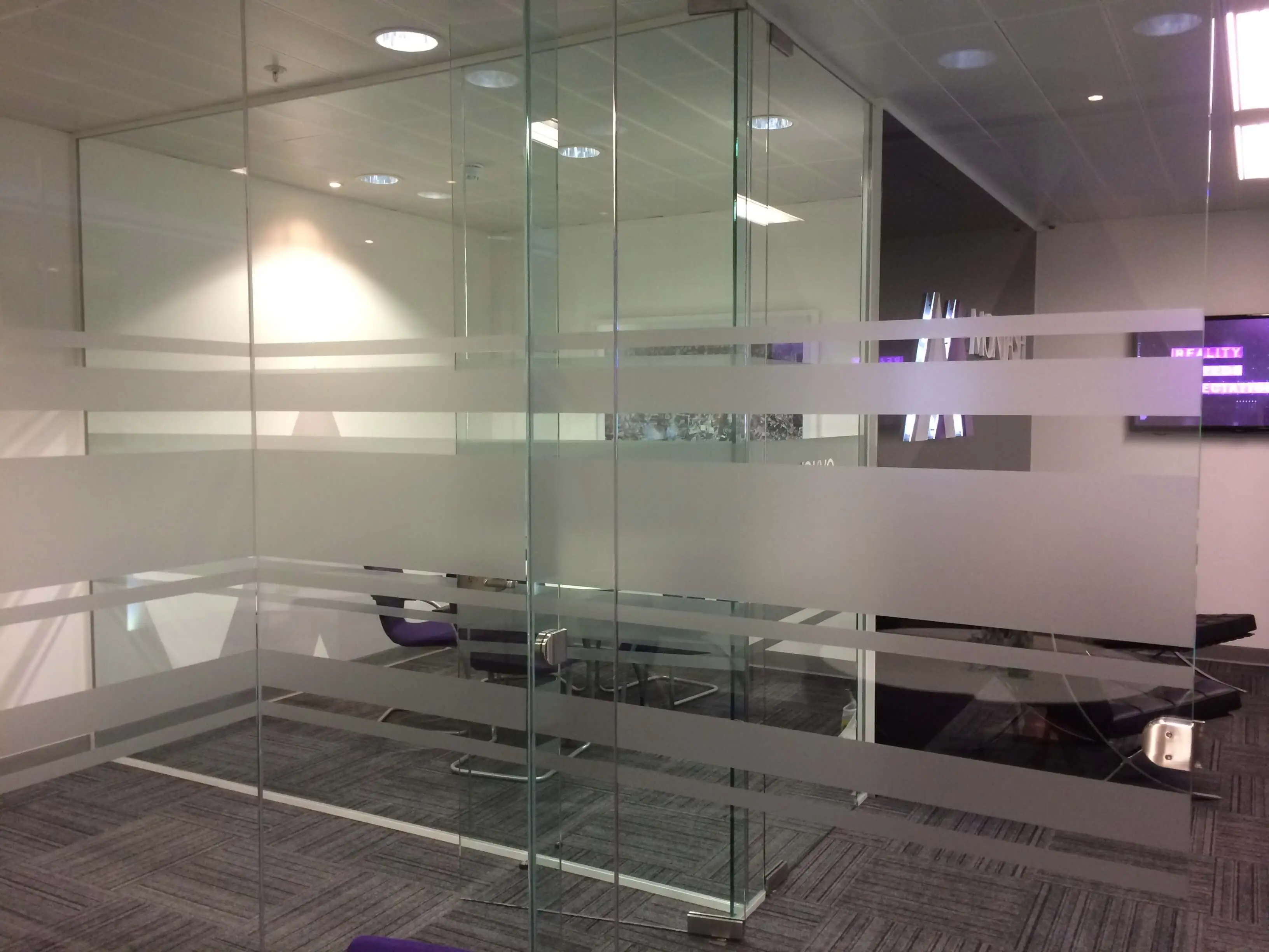 Multiple frameless glass doors and walls for meeting space