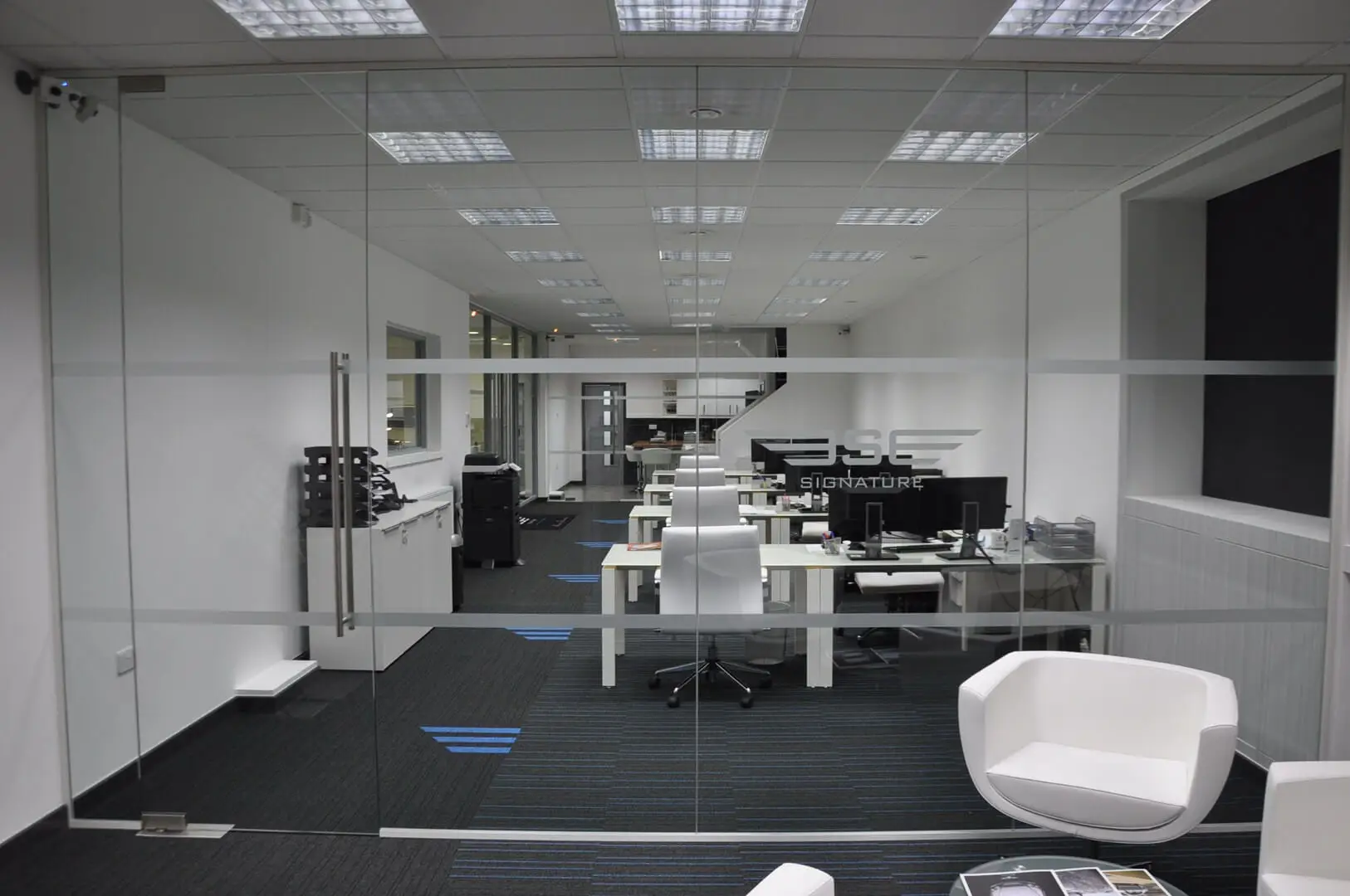 Office co working area with frameless glass partitions