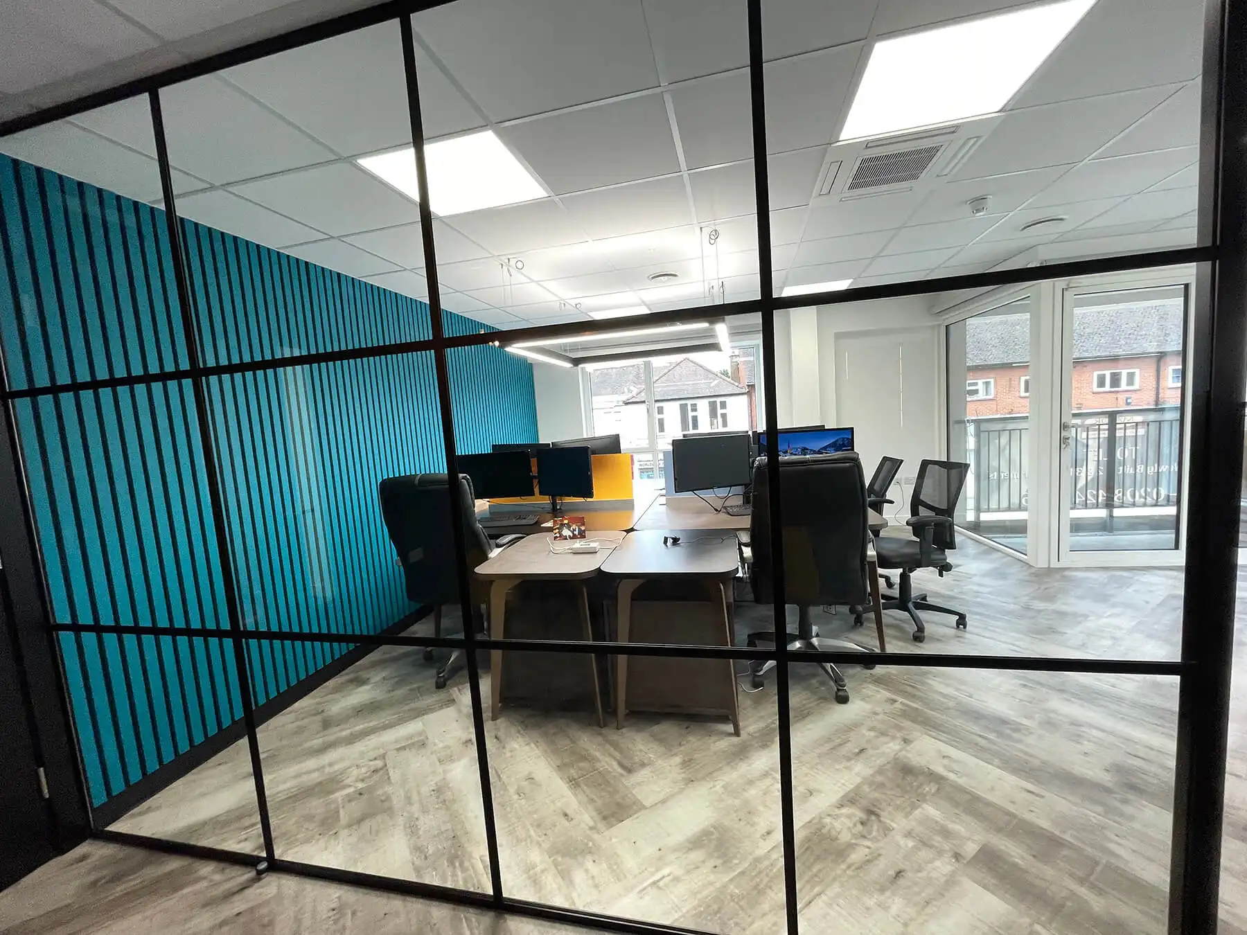 Office co working space with black framed glass partitions