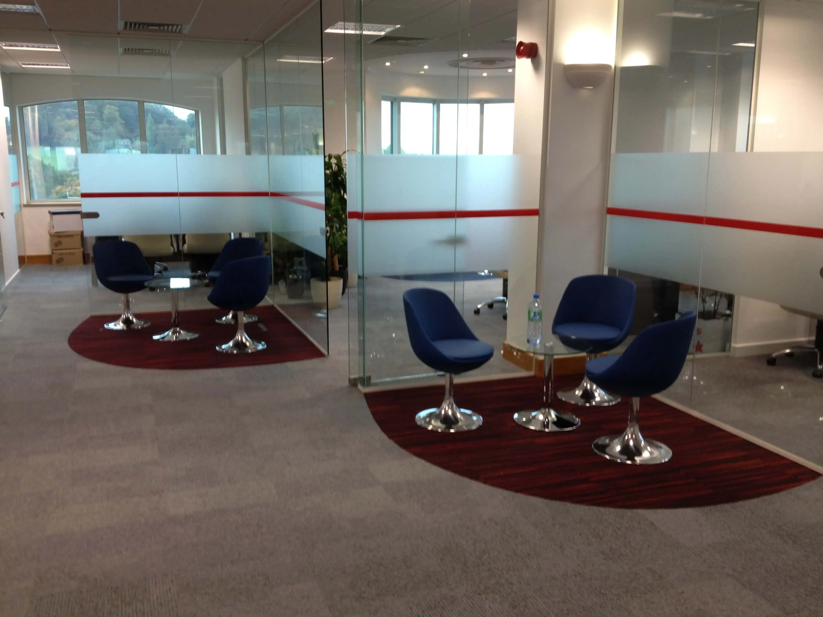 Office executive and waiting space separated with glass partitions