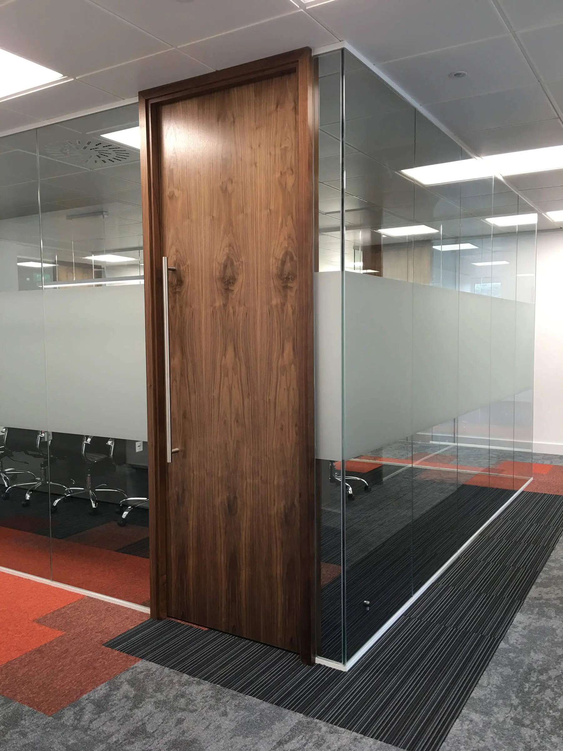 Office glass walls with high solid band and wood door