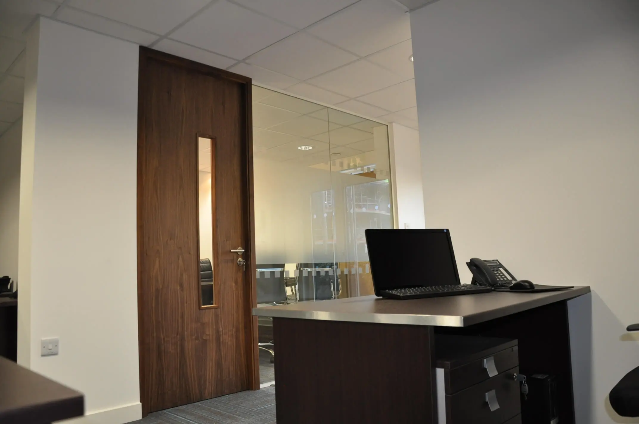 Office partitions with solid wood doors in executive office
