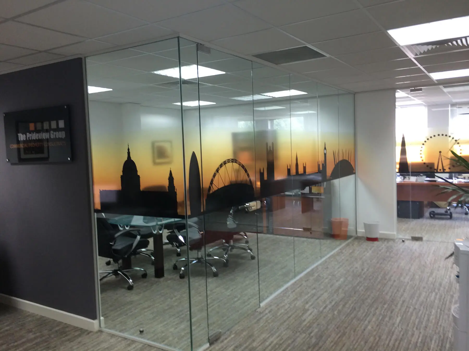 Office space divided with designer glass partitions and with deigner floor
