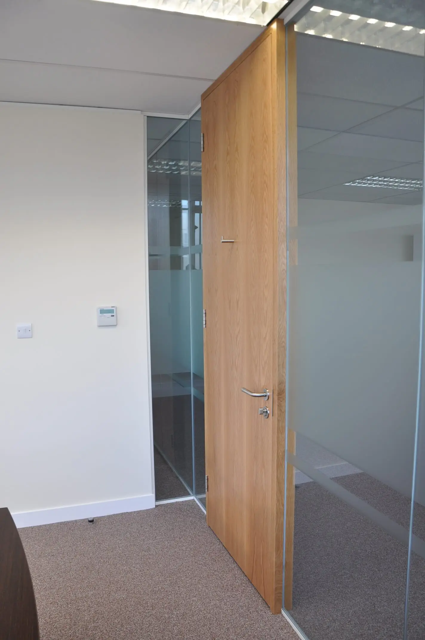 Office space partitioned with glass and solid door