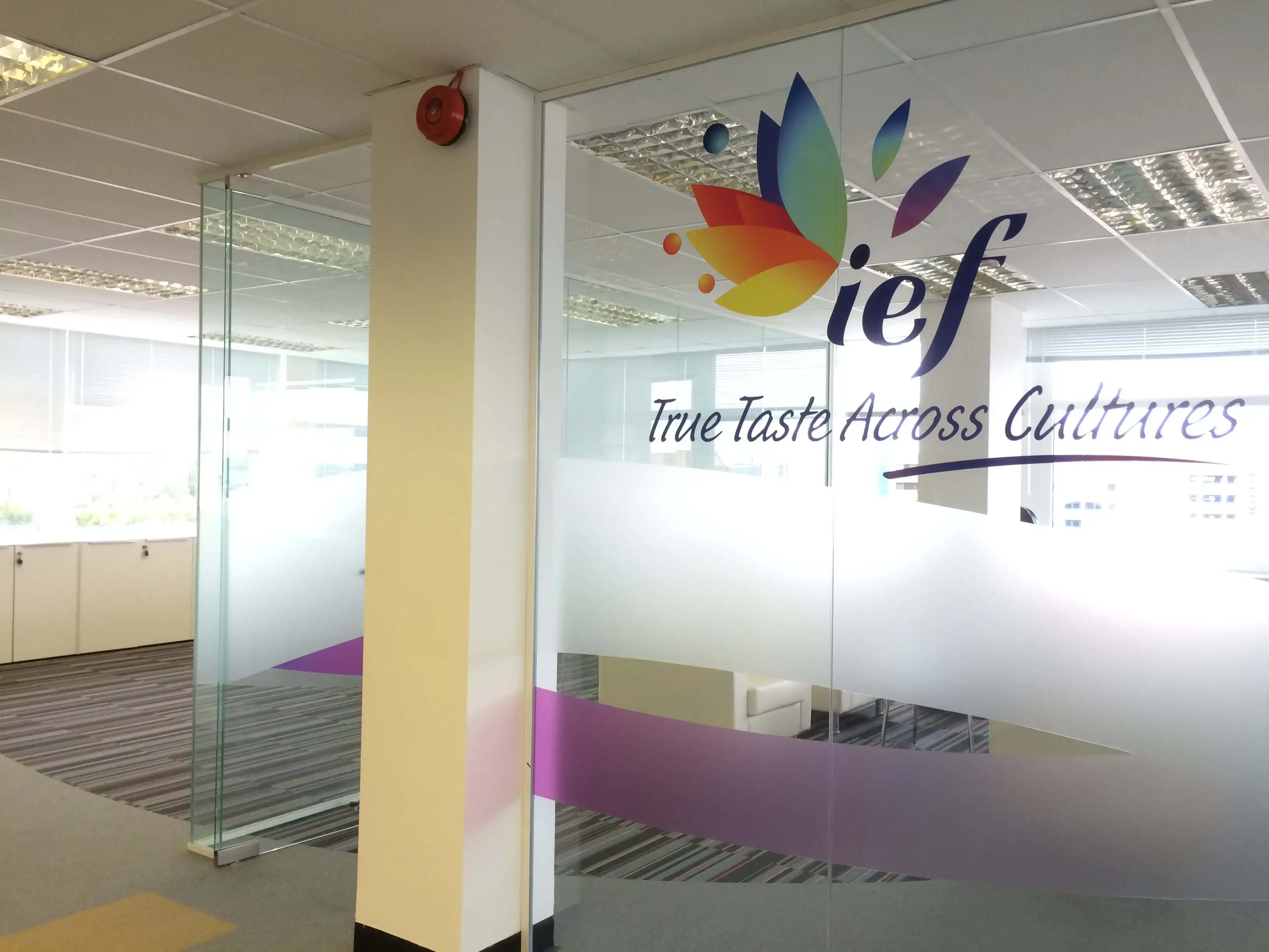 Office space partitioned with glass walls with designer manifestation and logo cut out
