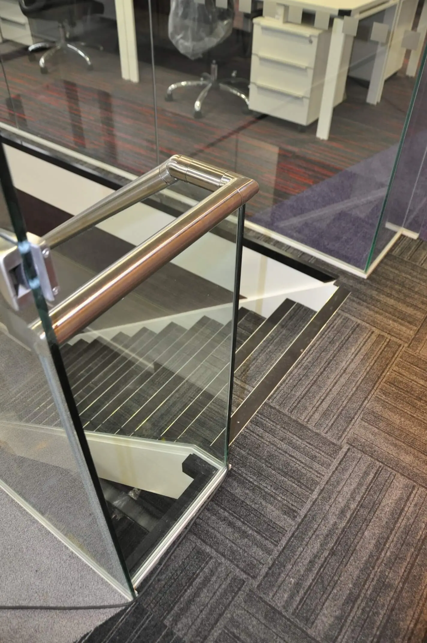 Office space with glass stairs and designer floor