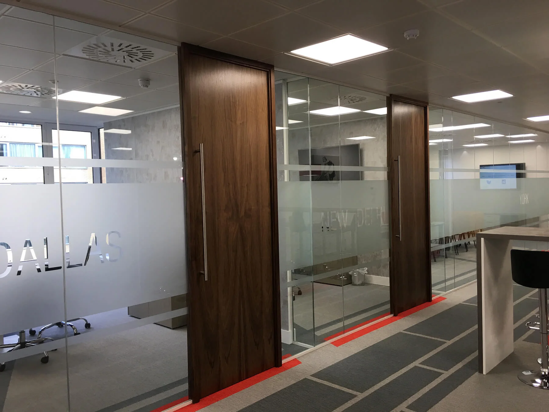 Office space with glass walls and wood doors