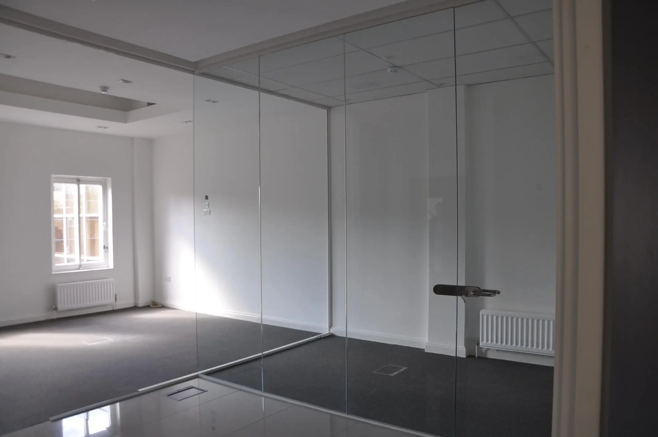 Office space with single glazed glass partitions and doors with lock