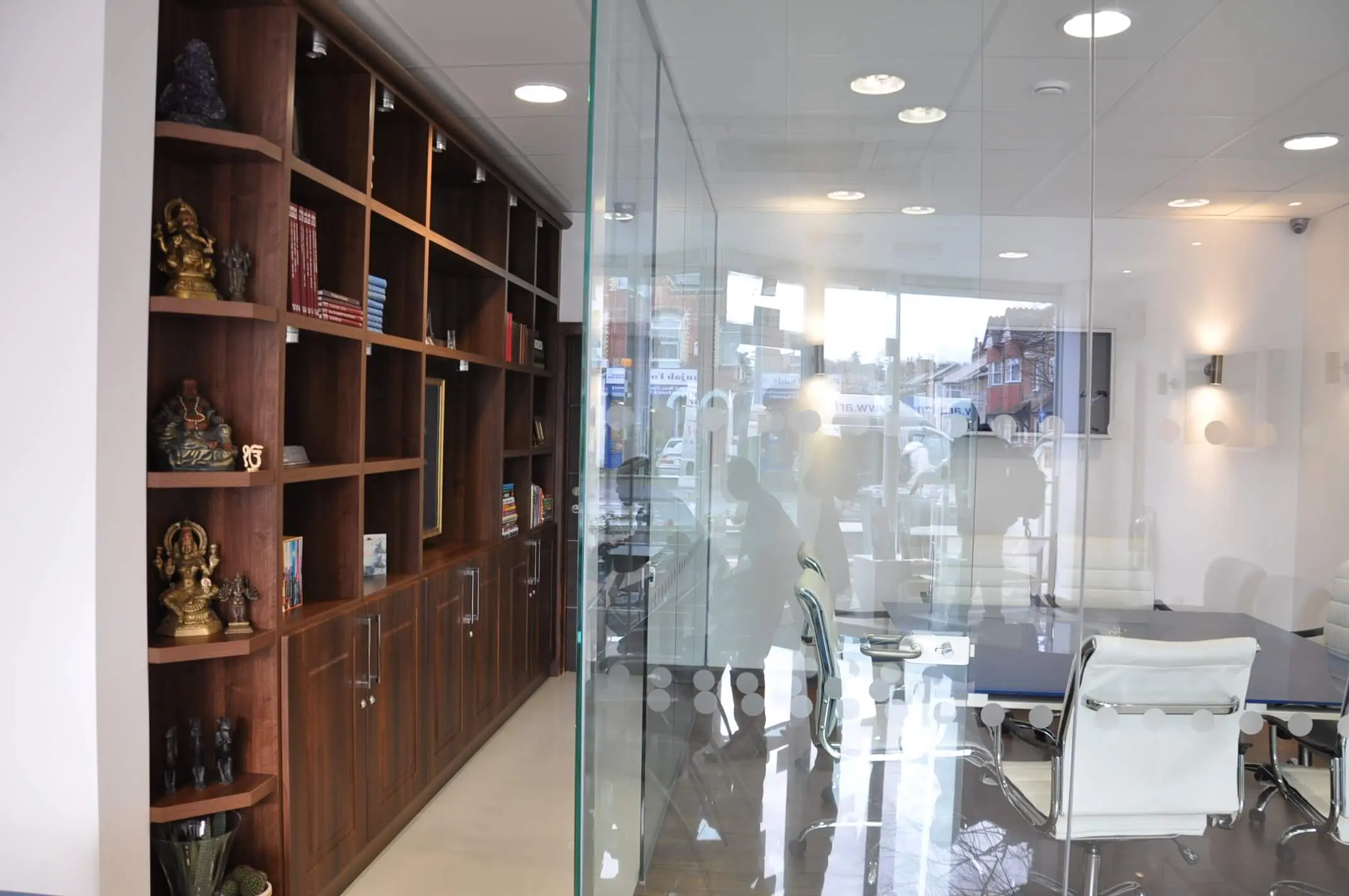 Office space with storage shelves and glass partitioned meeting room