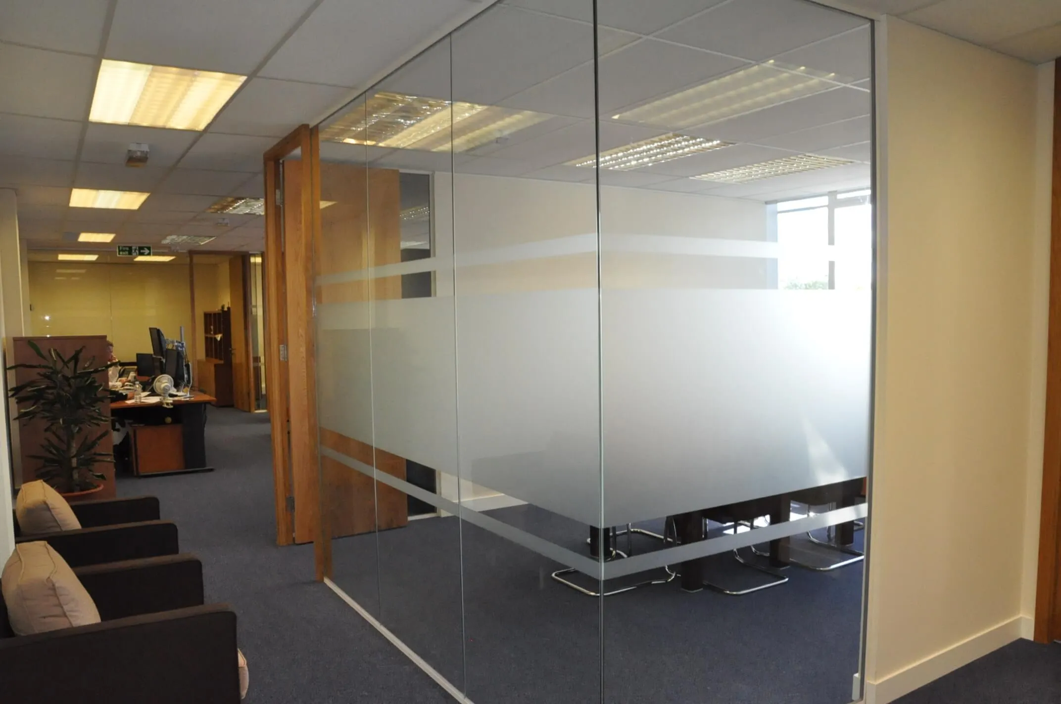 Office spaces divided with glass partitions with manifestation and solid door